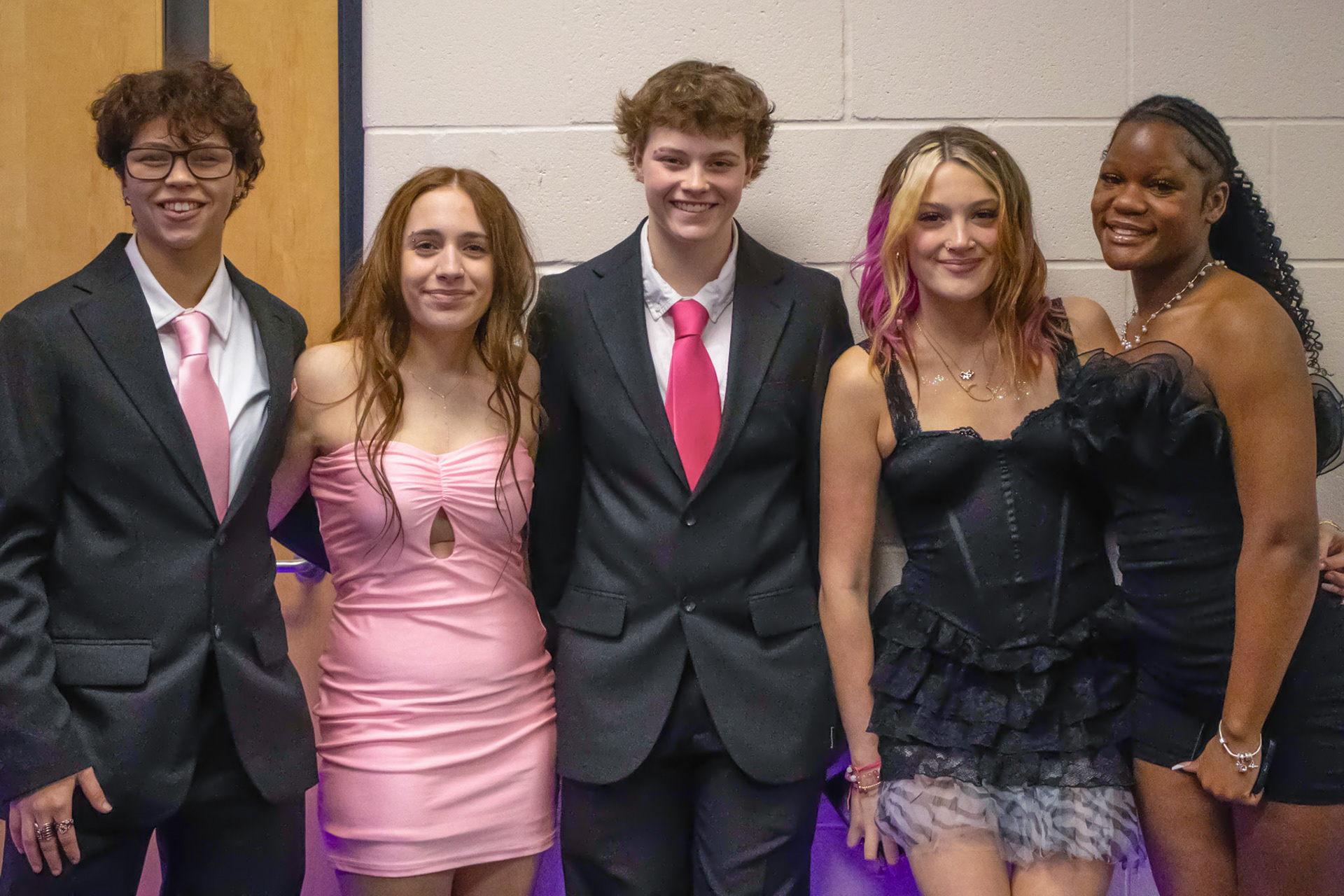 Neelani Jourden, Alyson Minton, Cassidy Collins, AhNya Pittman, and Lilli Ward wrap their arms around each other for the camera. (Photo by Ella-Grace Wickens)
