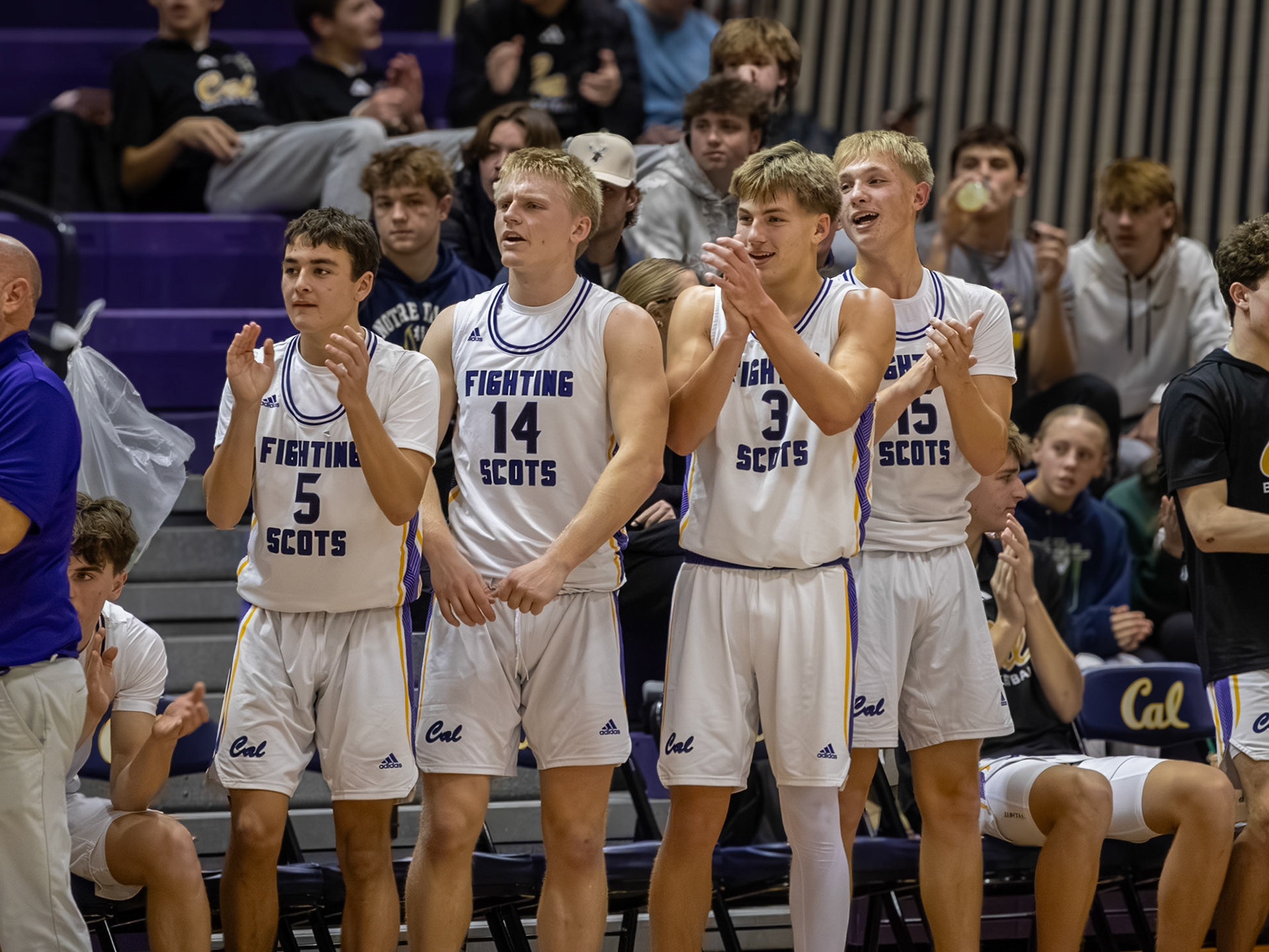 Connor Bloemers, Lincoln Senti, Ben Geerdes, and Bryce Backus engaged from the bench, cheering on their teammates. (Photo by Khloe Lowande)