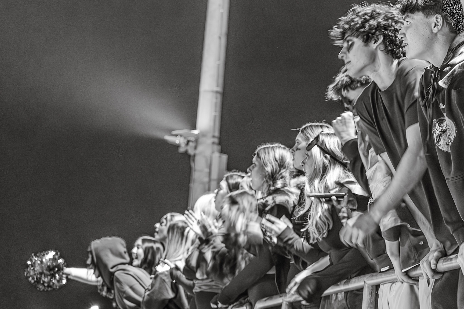 UNDER THE LIGHTS The student section keeps all eyes on the game against Rockford, anticipating the next play. (Photo by Abby Skibinski)