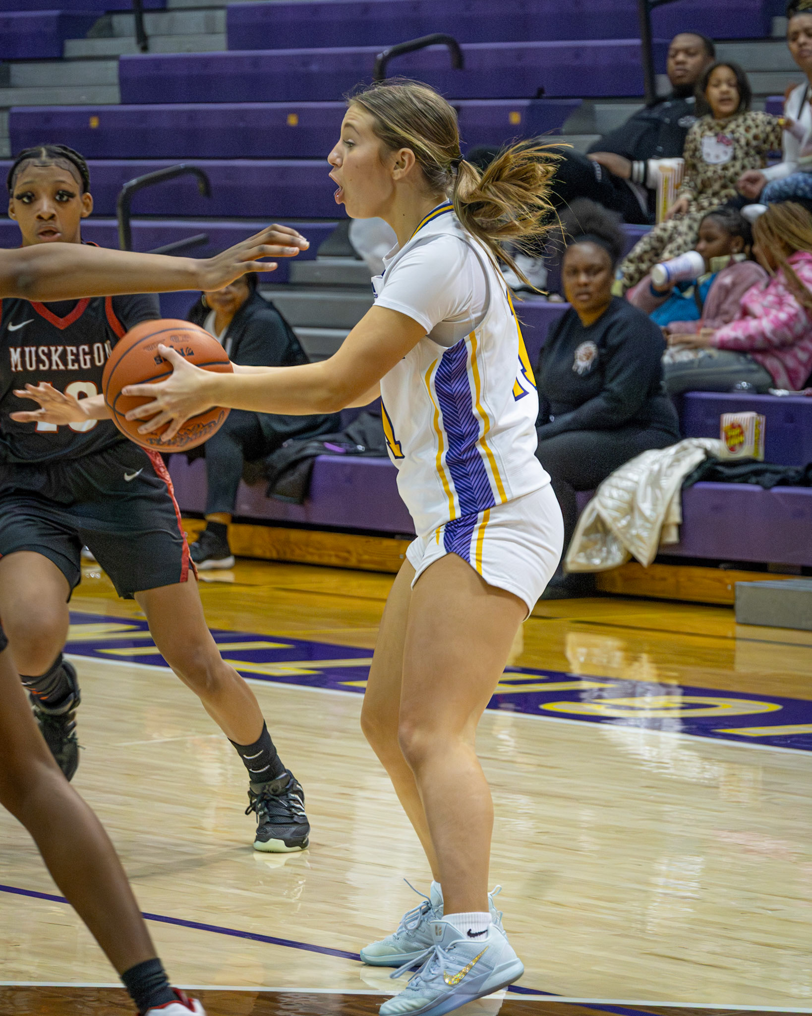 STRONG DRIVE Baylee DeVries pushes past a Muskegon defender while protecting the ball in varsity action. (Photo by Taya Penoes)