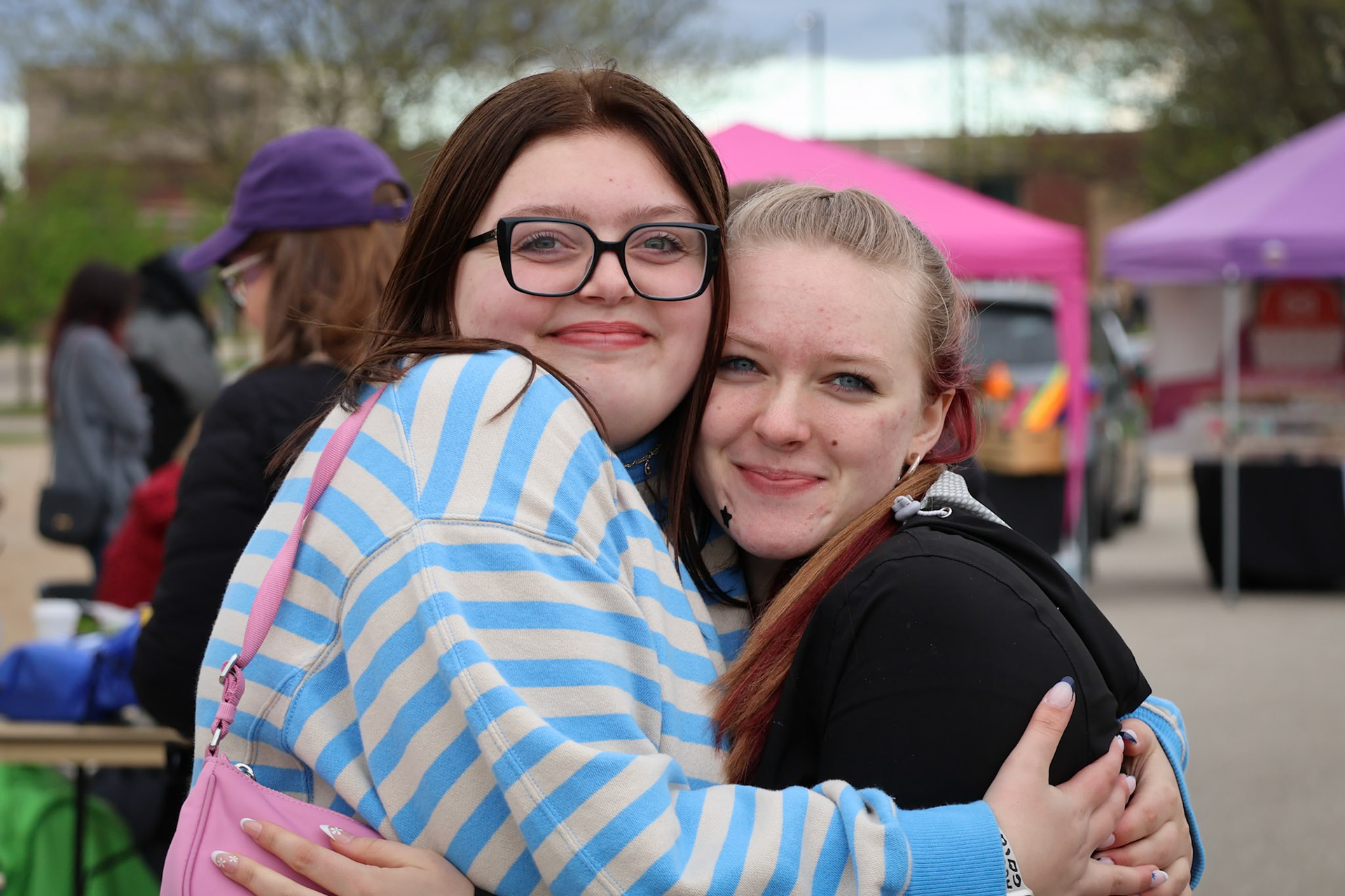 Juniors Elsha Bytwork and Ashlyn Nicoles share a hug at the Spring Carnival. Next stop: elephant ears. (Photo By Brianna Severson)