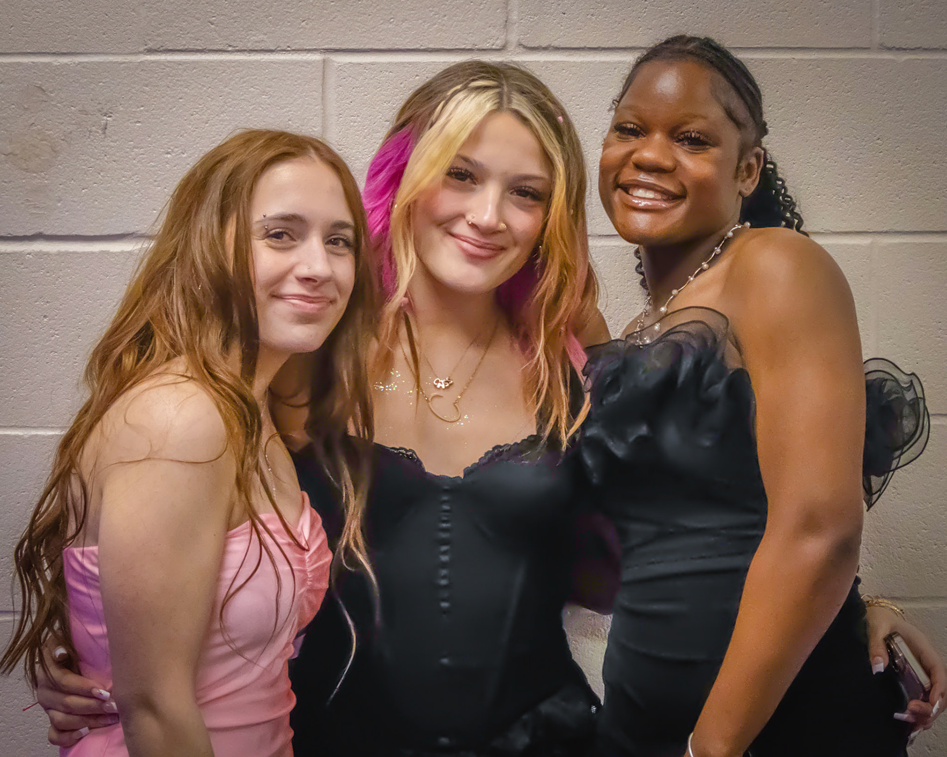 Grouping together for a quick photo: Cassidy Collins, AhNya Pittman, and Alyson Minton. (Photo by Ella-Grace Wickens)