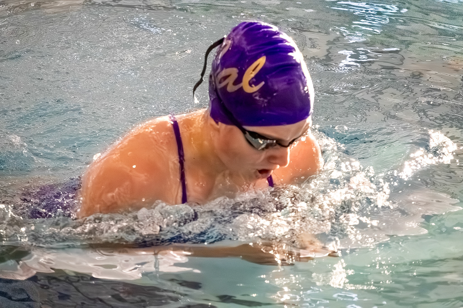 BEAUTIFUL BREASTSTROKE  Freshman Madelyn Foerch powers through the 100-yard event, one of the final races of the meet. (Photo by Hailey Thayer)