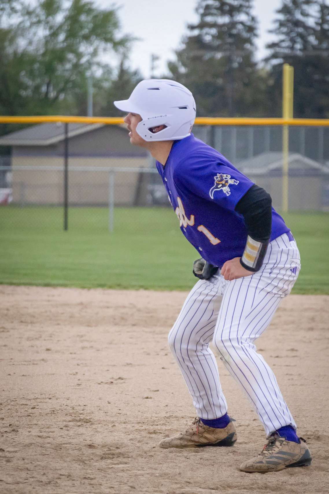 Keeping his eyes up Jace Vosburg looks over at his 3rd base coach waiting for a steal sign or the sign to run. (Photo by Ella-Grace Wickens)
