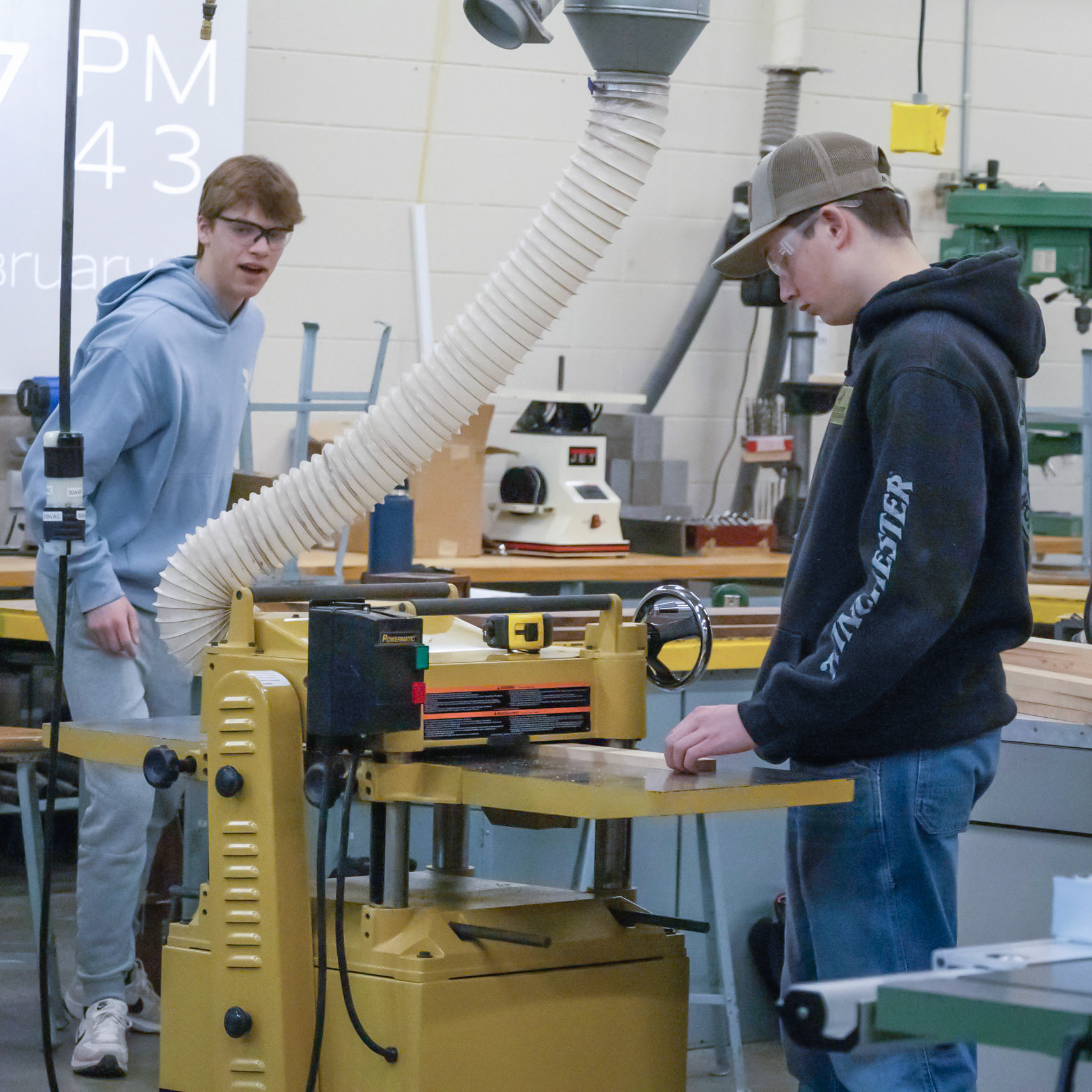 CRAFTED Working carefully at the planer, Evan Debrie smooths and shapes a board while showing precision and safety in the woodworking shop. (Photo by Natalia Teneyuque)