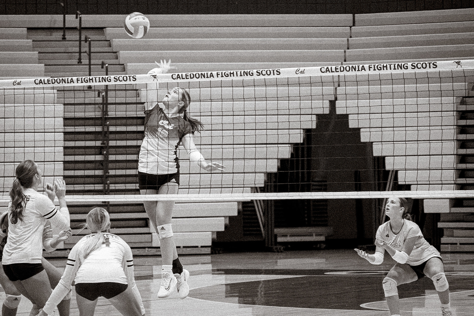 HIGH REACH  Nora Collins coils and leaps, focused on the ball above for a powerful attack. (Photo by Aslyn Crocker)