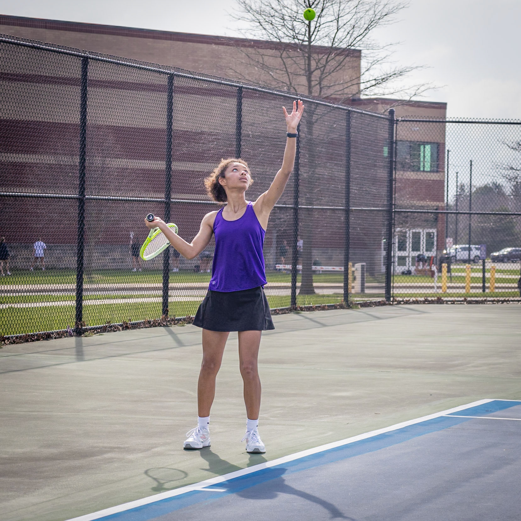 Mid-round, Yelena Wilks holds the lead as she prepares her next serve, tossing the ball strategically to maintain control of the game. (Photo by Abby Skibinski)