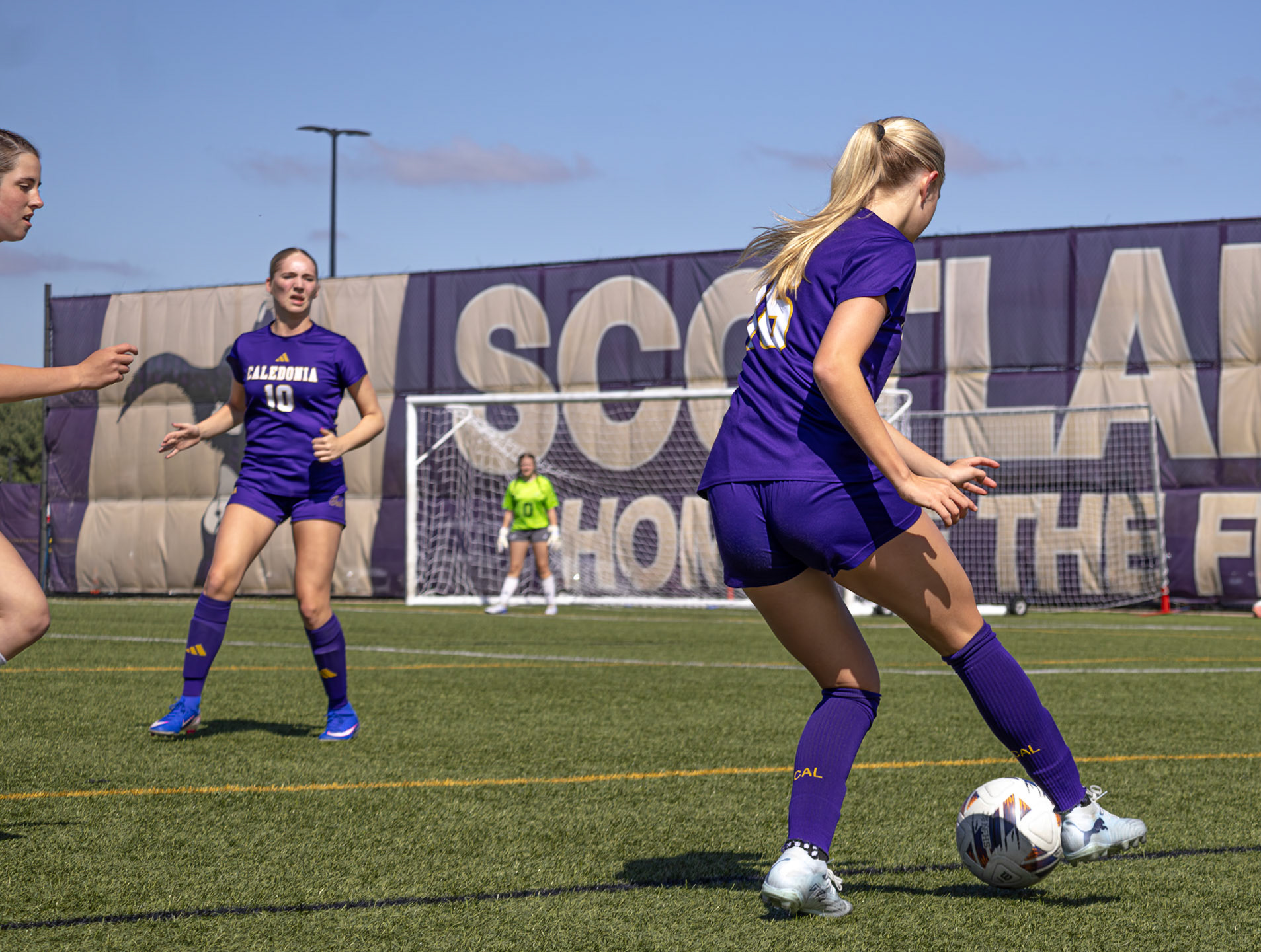 Laney Winstrom and Natalie Nelson connect on passes to keep the defender away. (Photo by Ellie VanderRoest)