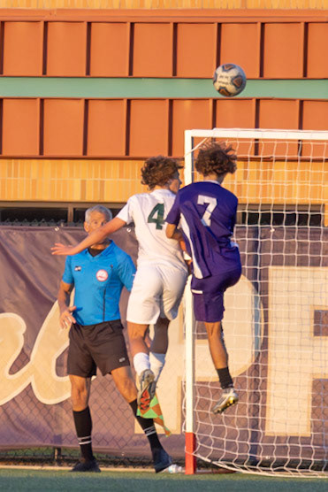 Owen Mancuso jumps to head the ball after a throw-in making contact with it, heading it out of bounce. (Photo by Brianne Weih)