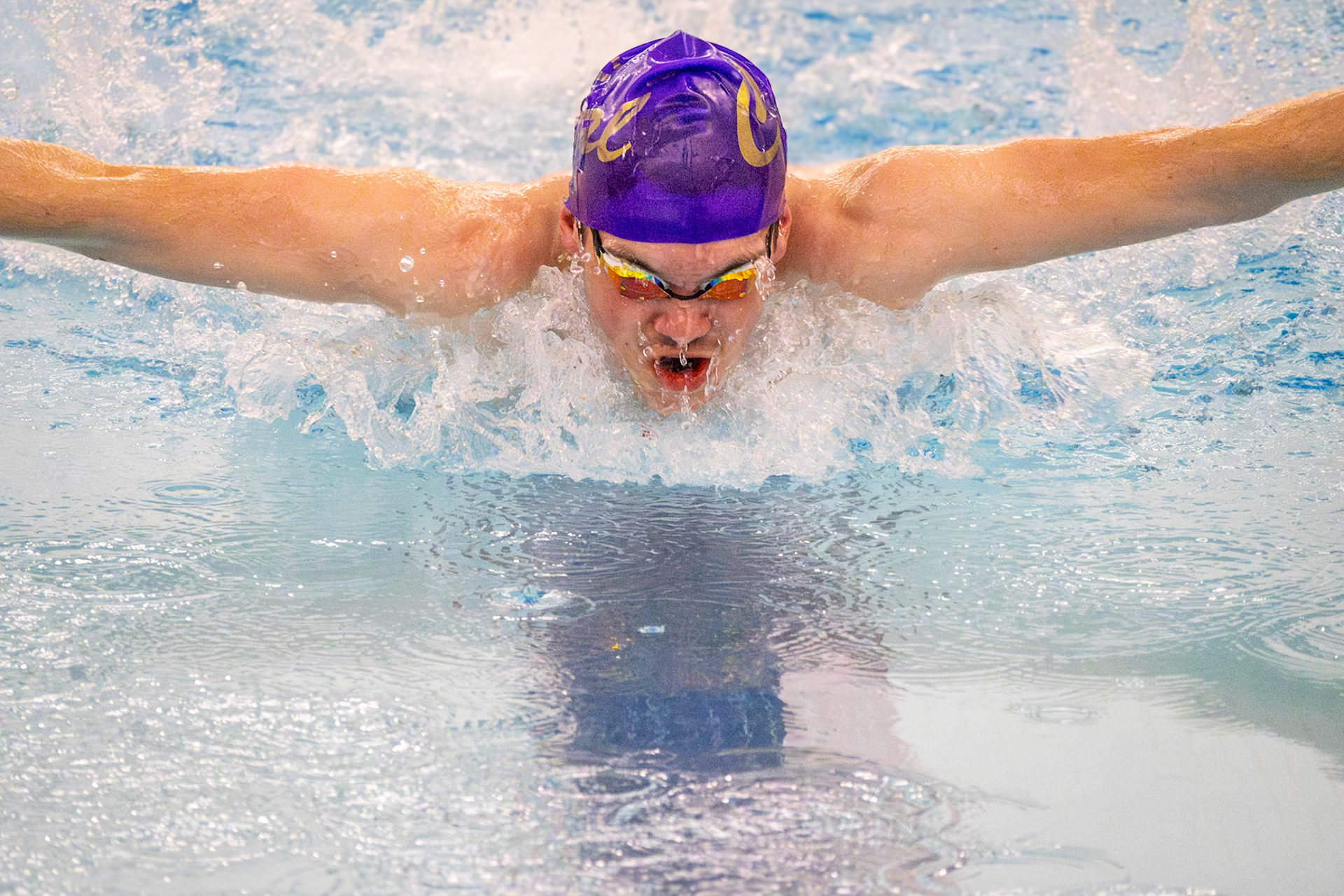 Andrew Barnum performs perfect form while swimming the 100-yard butterfly, dedicated to take the win for his team. (Photo by Hailey Thayer)