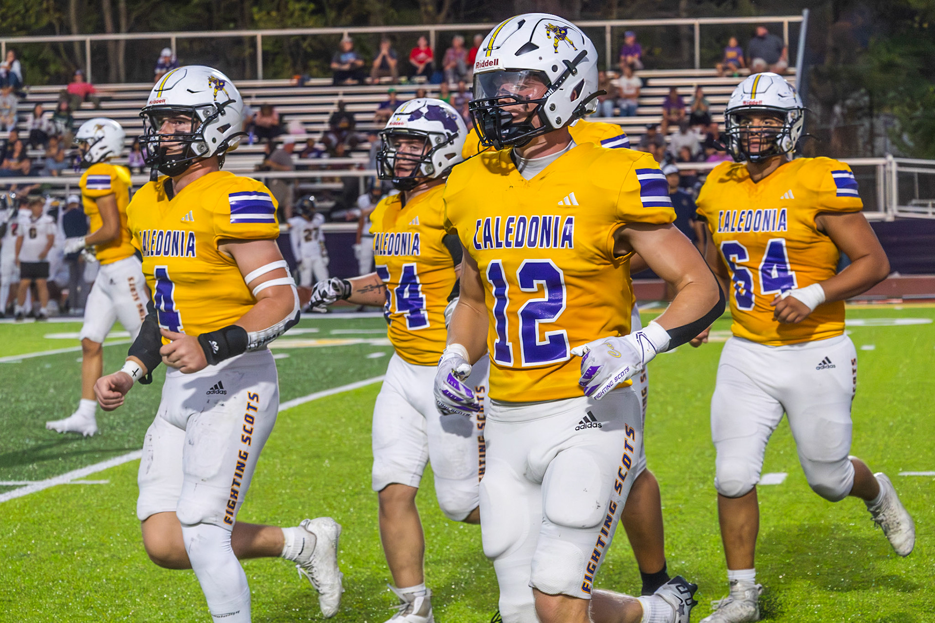 The Caledonia defensive line comes off the field along with linebacker Elliot Clark.(Photo by Leo Xiong)