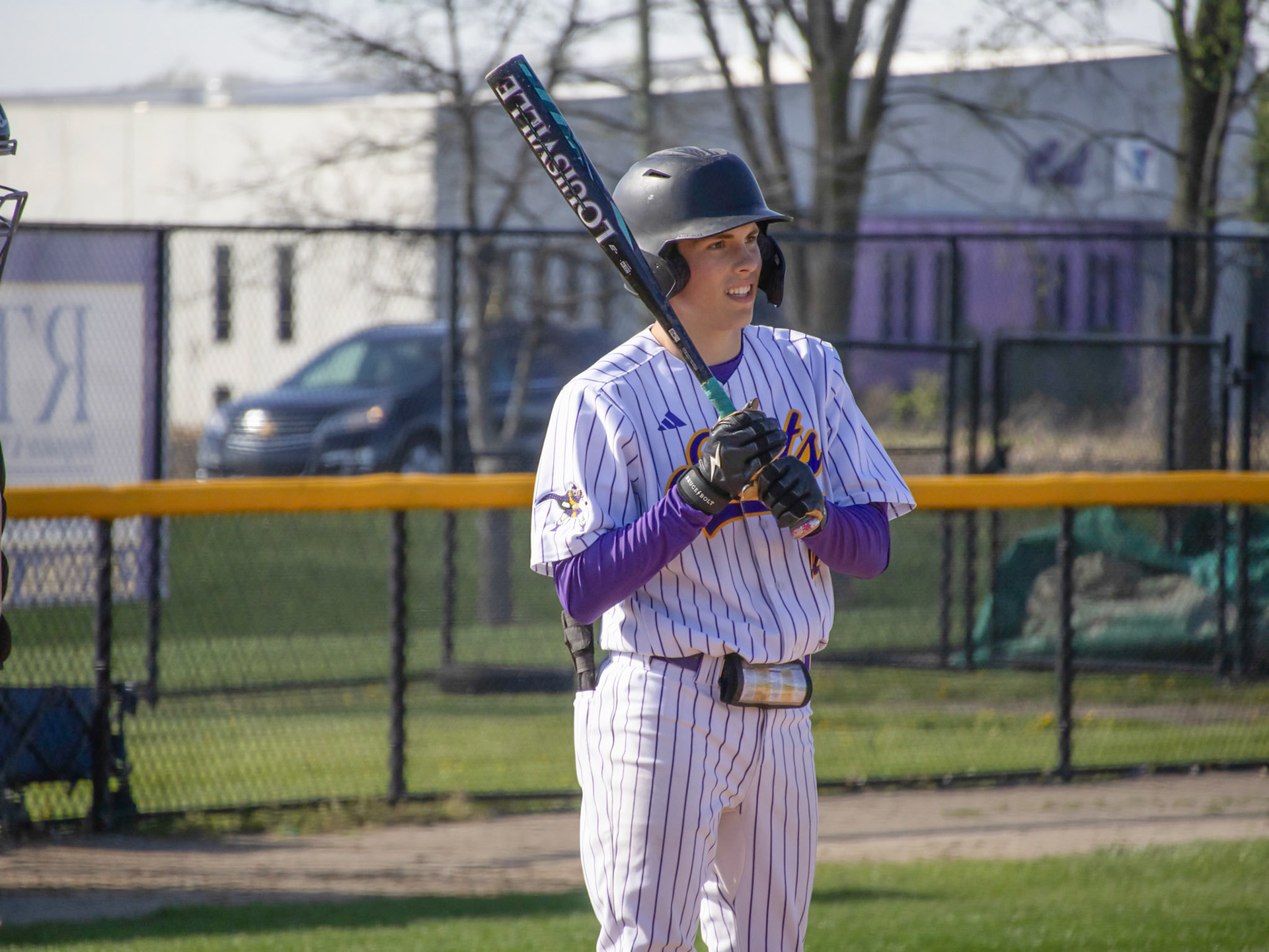 Stepping into the batters box, Logan Pratt looks to his coach for advice on his swing. (Photo by Ella-Grace Wickens)