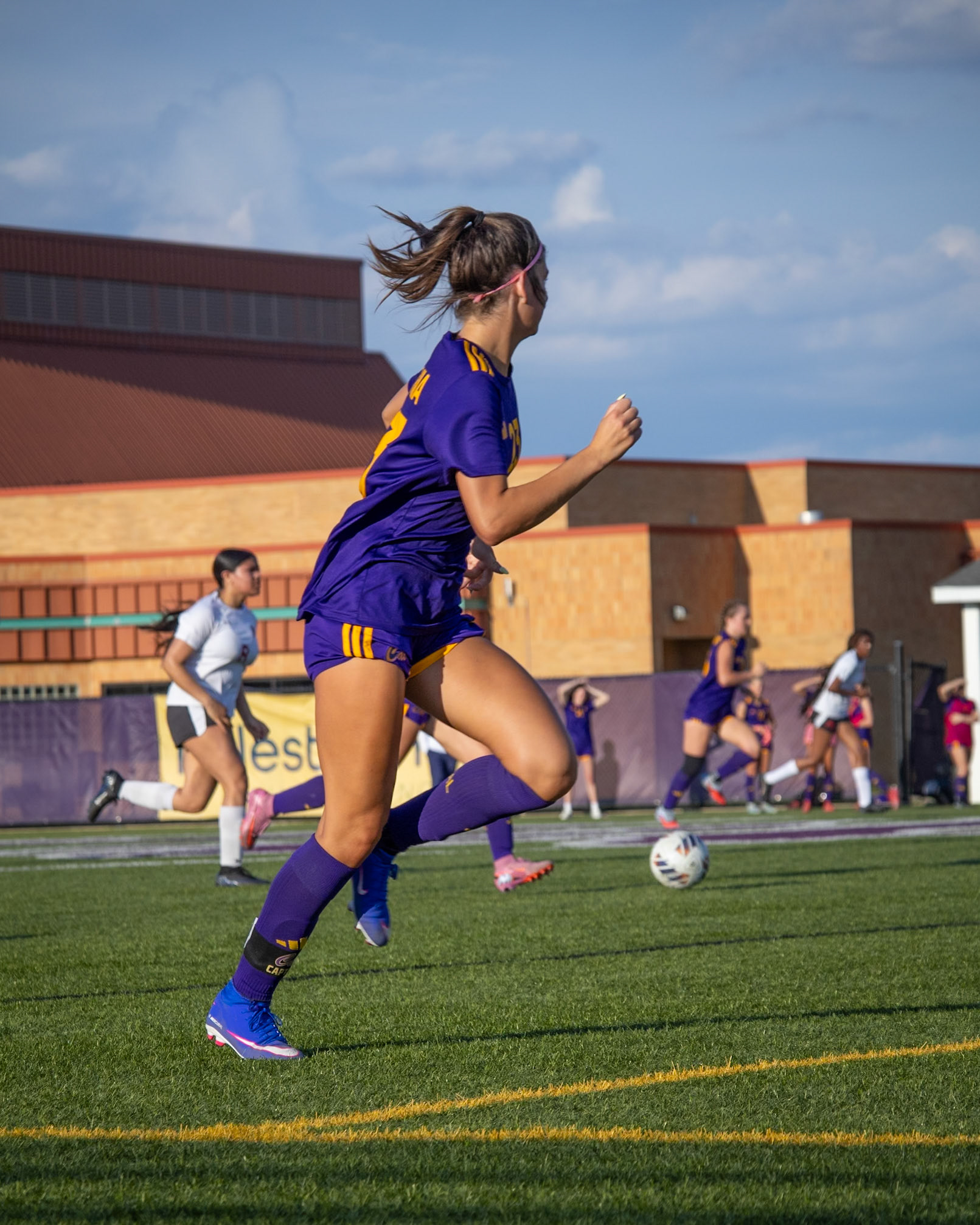 Kayla sprints downfield as her teammate sends the ball her way, breaking into open space. (Photo by Aibree Akers)