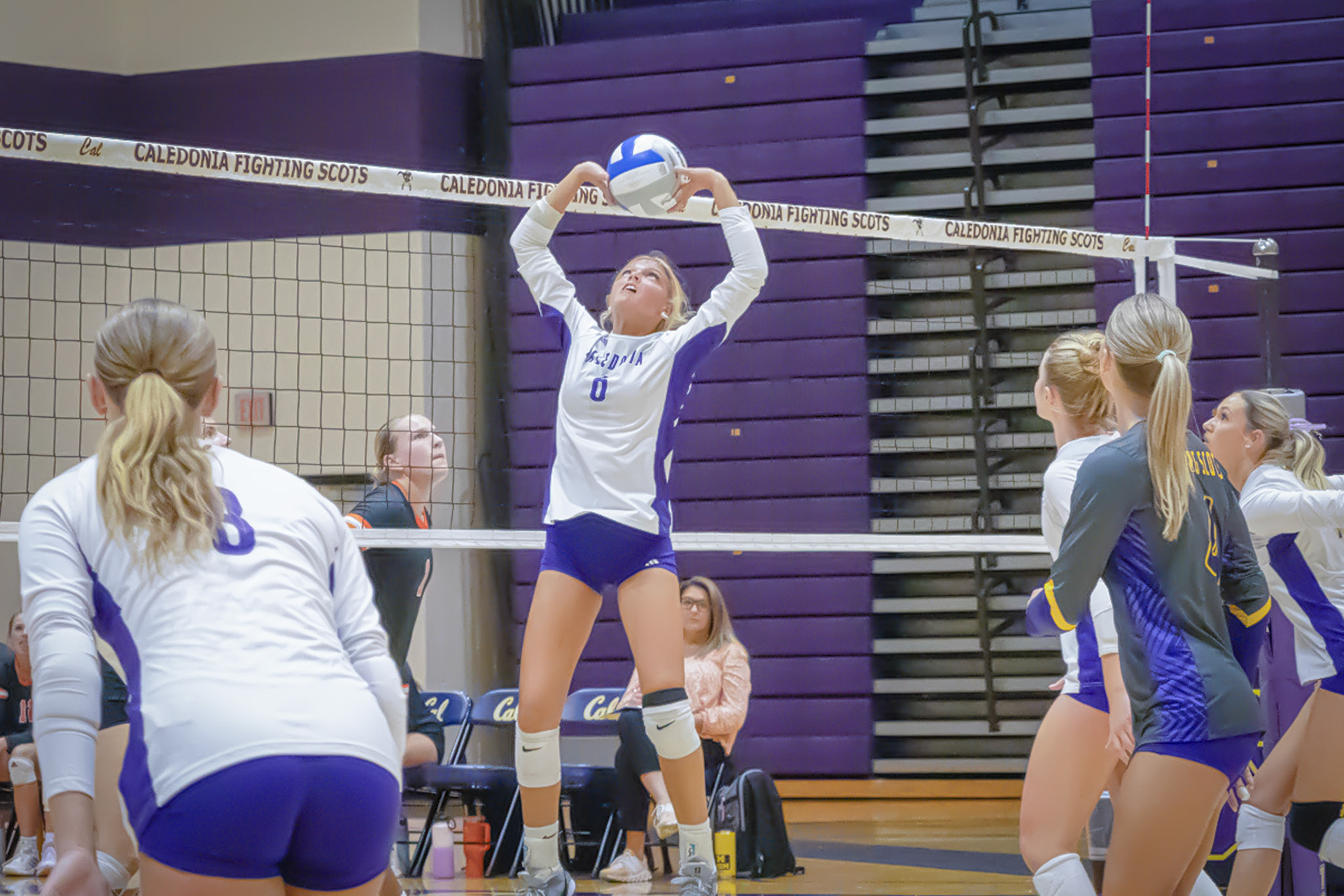 SET UP  Reese Stafford sets the ball up high to Kyla Charles going for the kill against Byron Center. (Photo By Tana Coates)