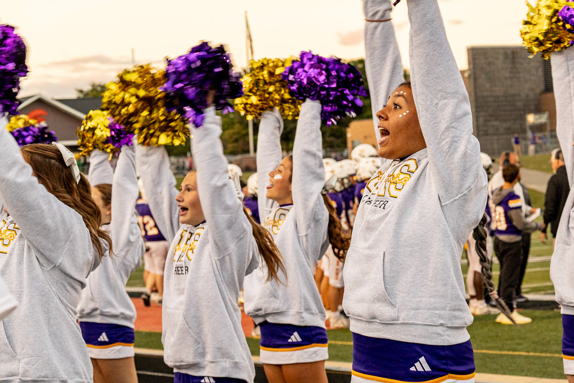 LOUD AND PROUD  Varsity Sideline Cheer hypes the student section up with Caledonia in the lead against the Reeths-Puffer Rockets. (Photo by Avarey Lippert)