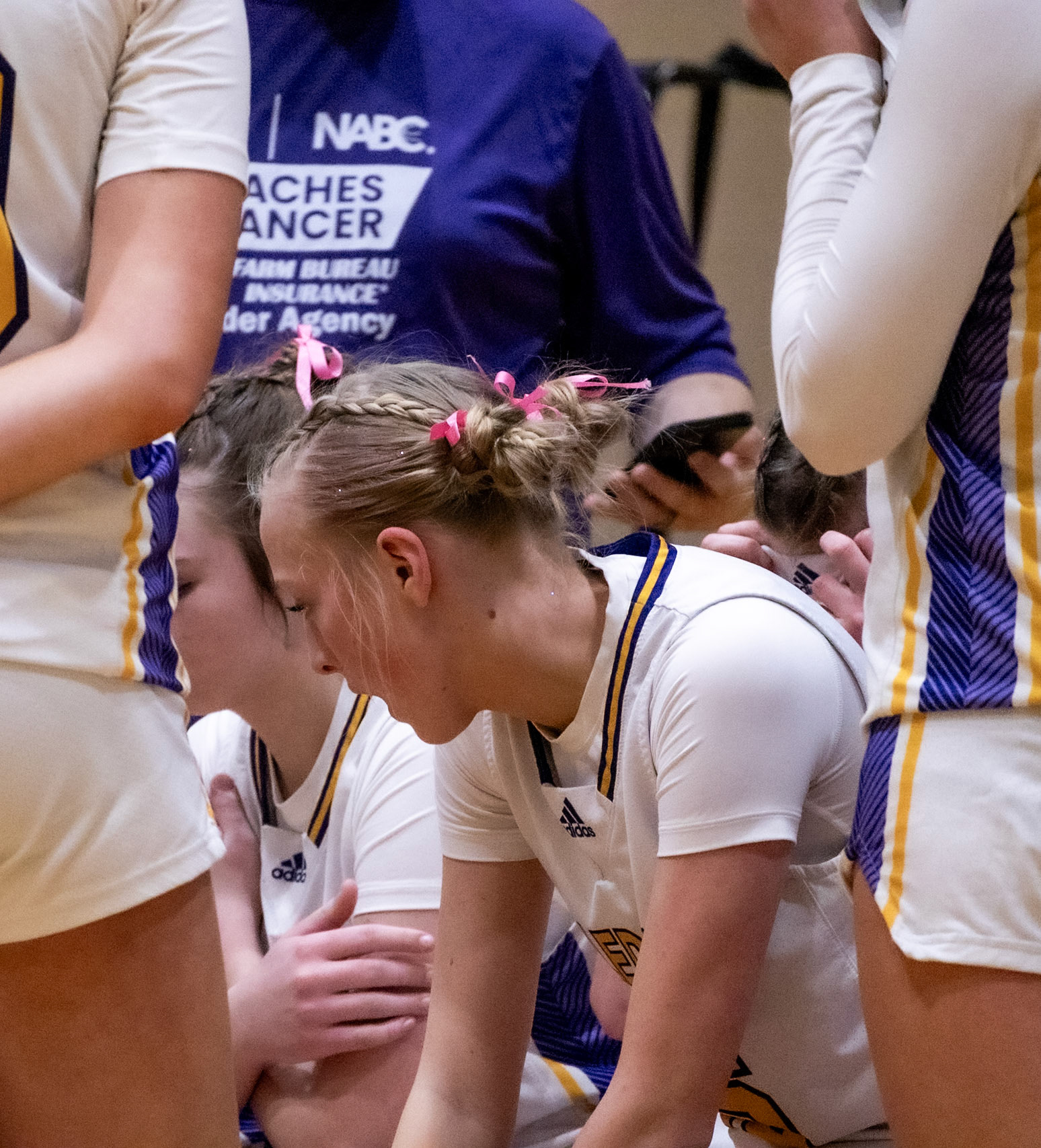 Freshman Ellie Radel take's in coach's advice during a timeout. (Photo by Abigail Douglass)