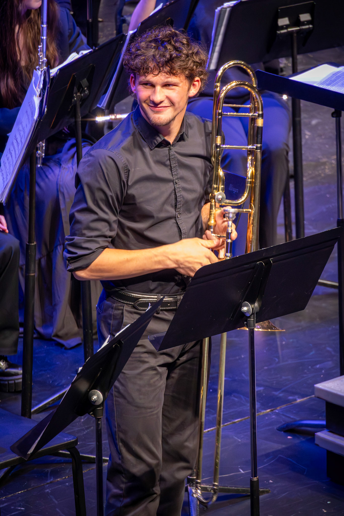 Ben Moss smiles while listening closely to the band director after their duet performance together. (Photo by Mackenzie Popma)