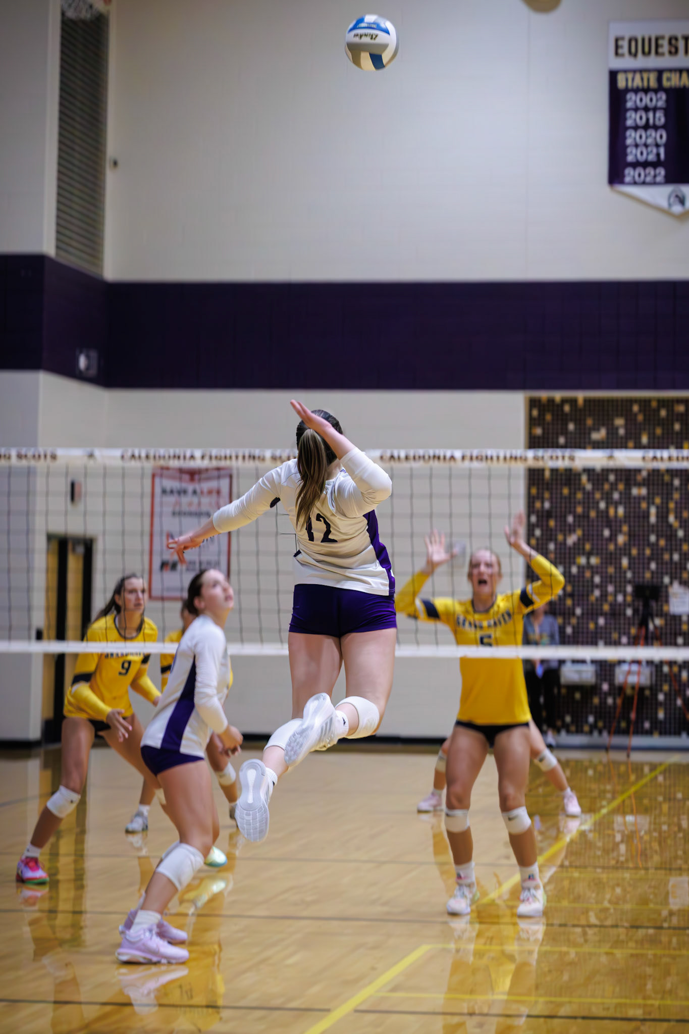 Aubrey Renolds elevates for a dynamic back-row swing, catching the opposing blockers flat-footed. (Photo by Joseph Bawi)
