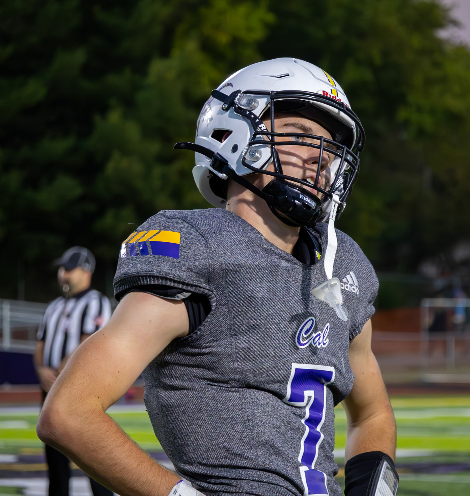 Oliver Olmstead studying his coaches words with percision, absorbing the plan for the next play. (Photo by Khloe Lowande)