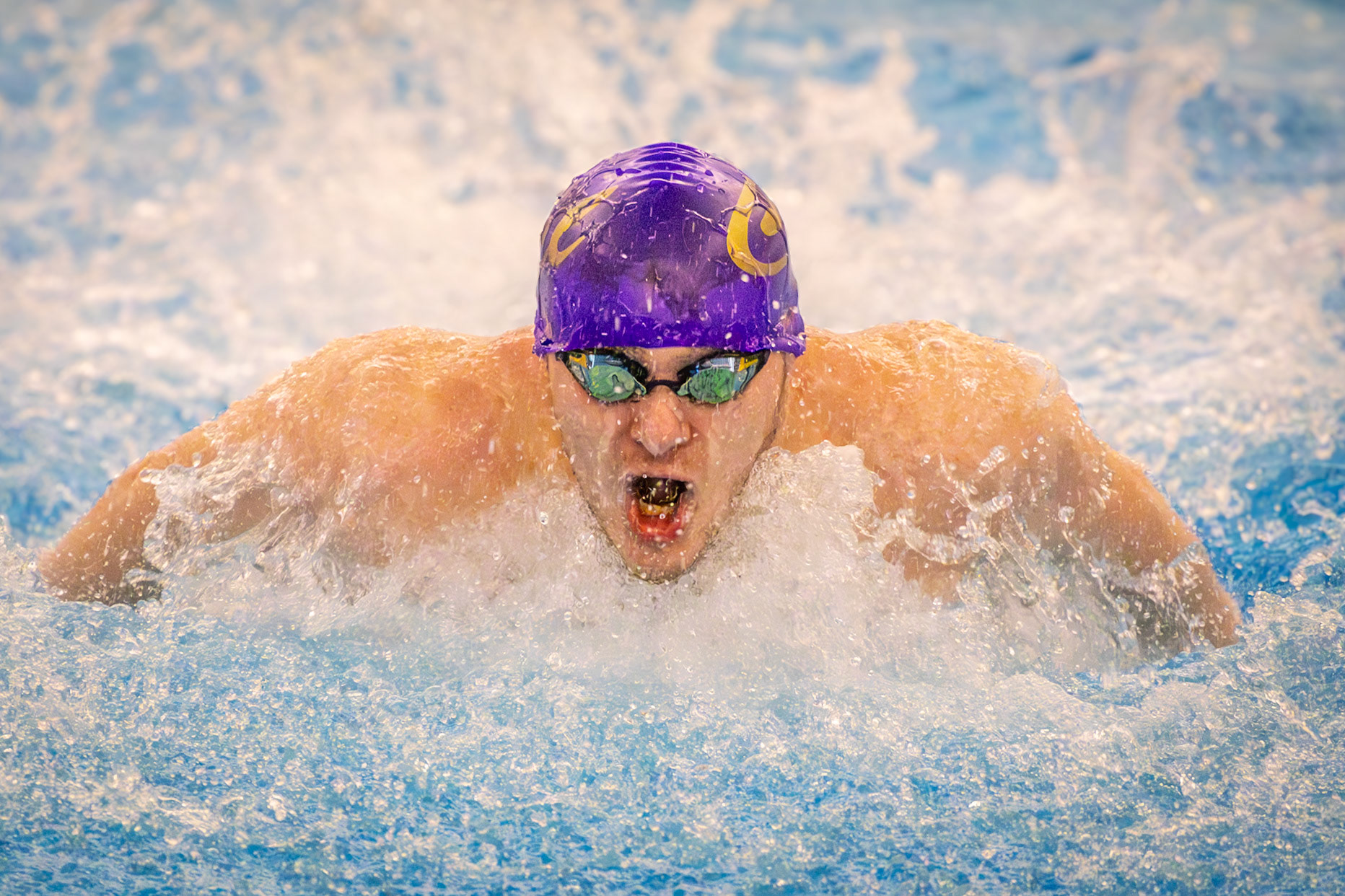 Nolan Fitzgerald races the 100-yard butterfly during the meet against the Wayland Wildcats, giving an impressive performance. (Photo by Hailey Thayer)
