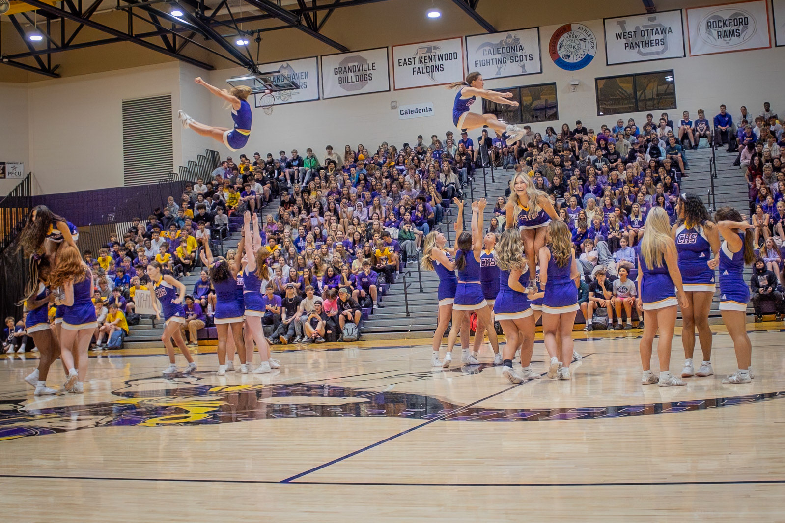 FLYING HIGH As Caledonia varsity sideline cheer performs at the assembly, students in the bleachers watch eagerly after a basket-toss stunt. (Photo by Aslyn Crocker)