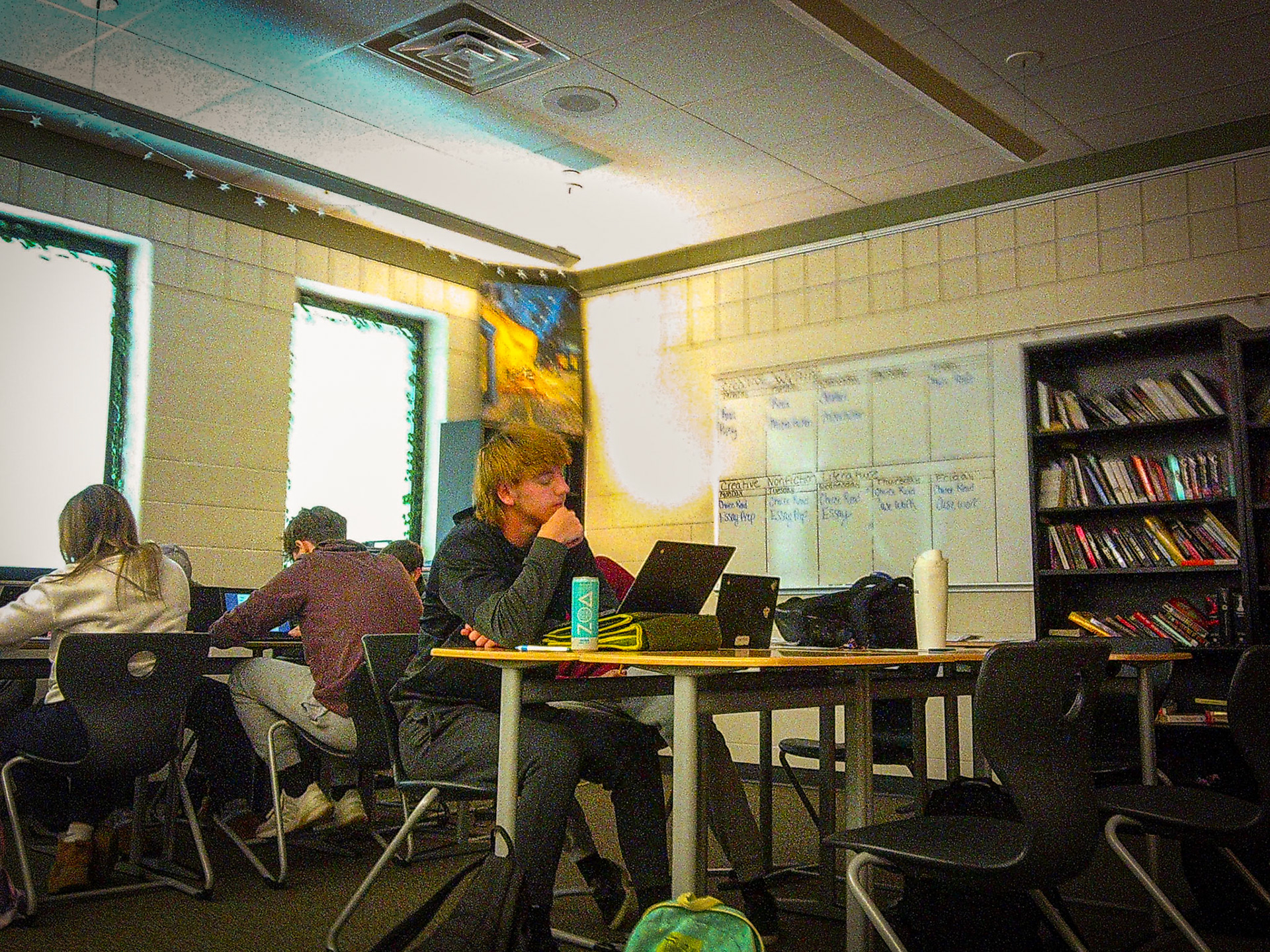 Senior Alex Spinney thinks about his next steps for his short story as he writes his plot diagram. (Photo by Avarey Lippert)