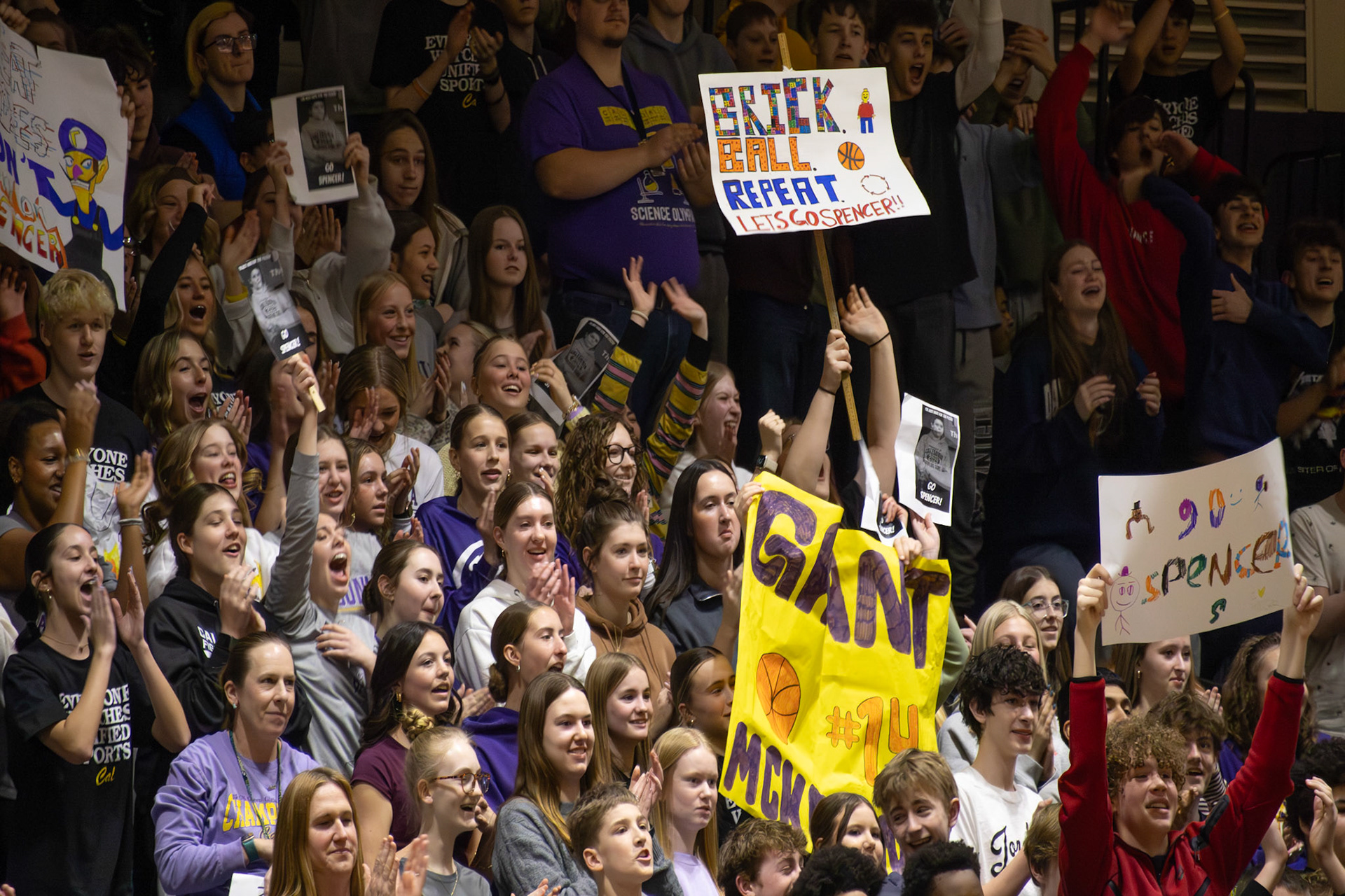 With handmade signs in hand, freshmen show their support by cheering on Unified players throughout the game. (Photo by Abby Skibinski)