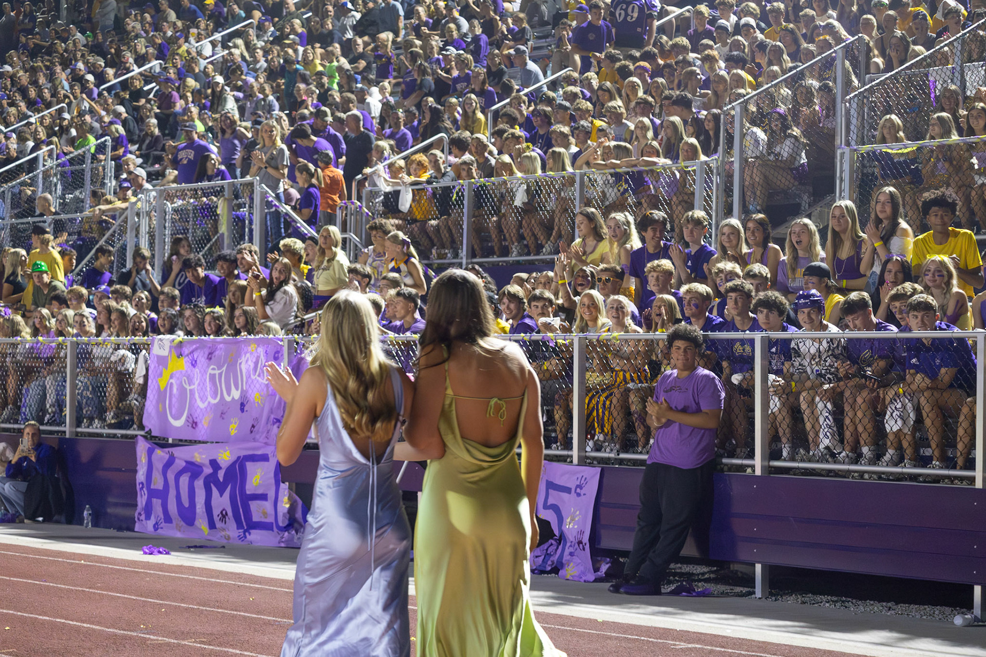 Lyla Keller and Peyton DeHorn walk in front of student section representing student council. (Photo by Milana Rico)