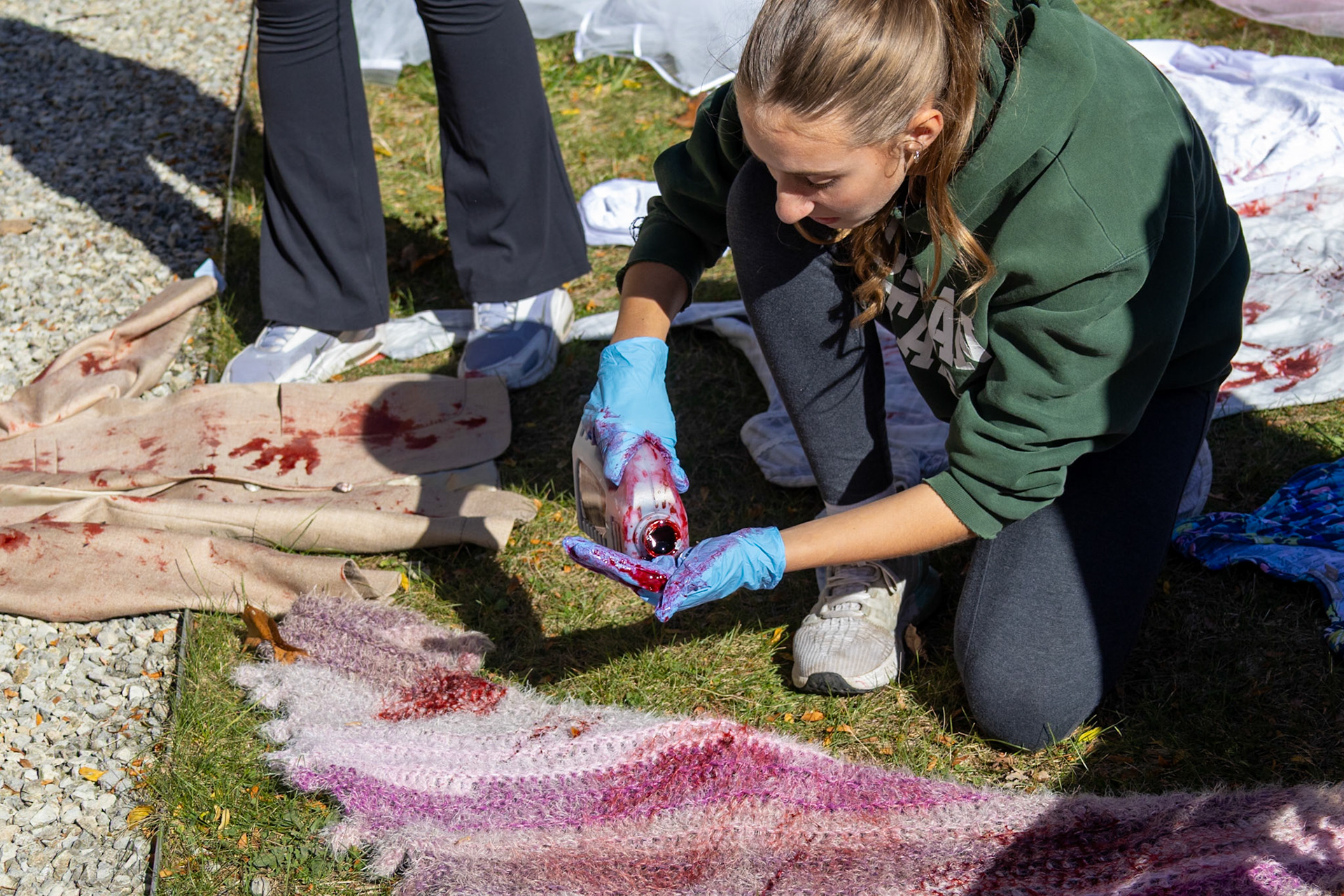Freshman Natalie James prepares for a spooky Fright Night, complete with fake blood and all the scares. (Photo by Madelynn Pittman)