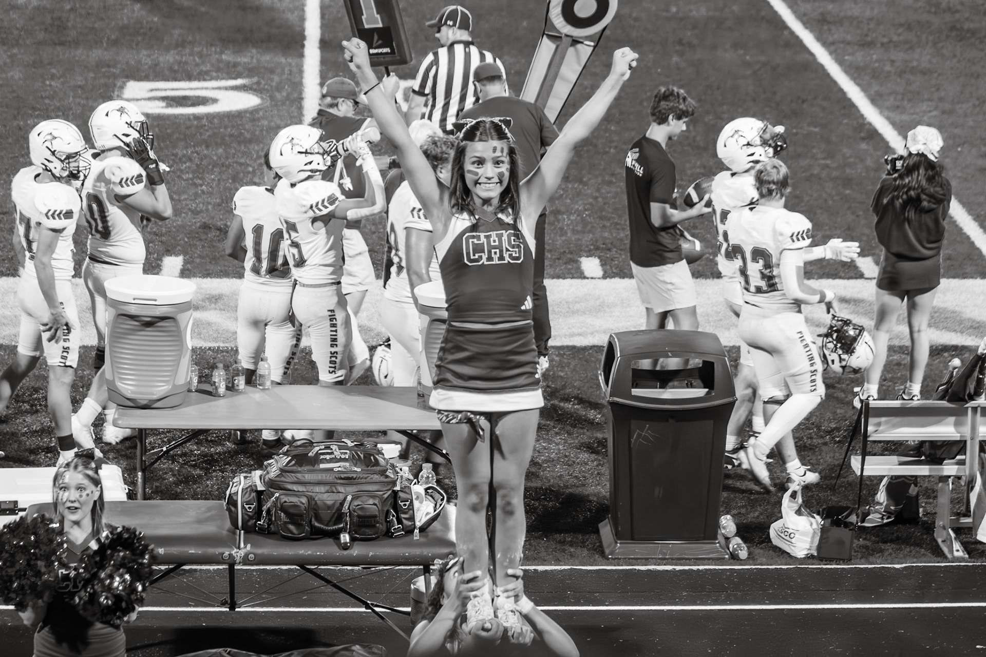 Adriana Twigg is lifted into the air with a smile, gearing up for a cradle at the varsity Hudsonville game. (Photo by Taya Penoes)