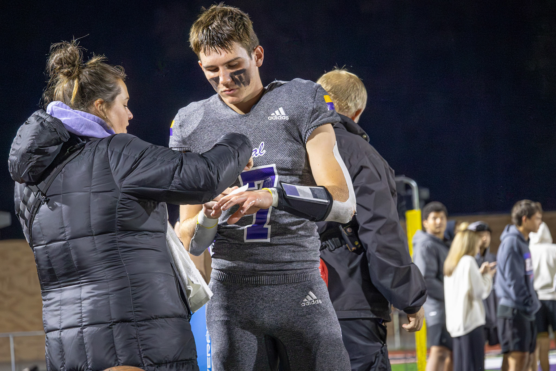 Casey wraps Oliver Olmstead's hand, helping him play on through injury. (Photo by Sydney Palmer)