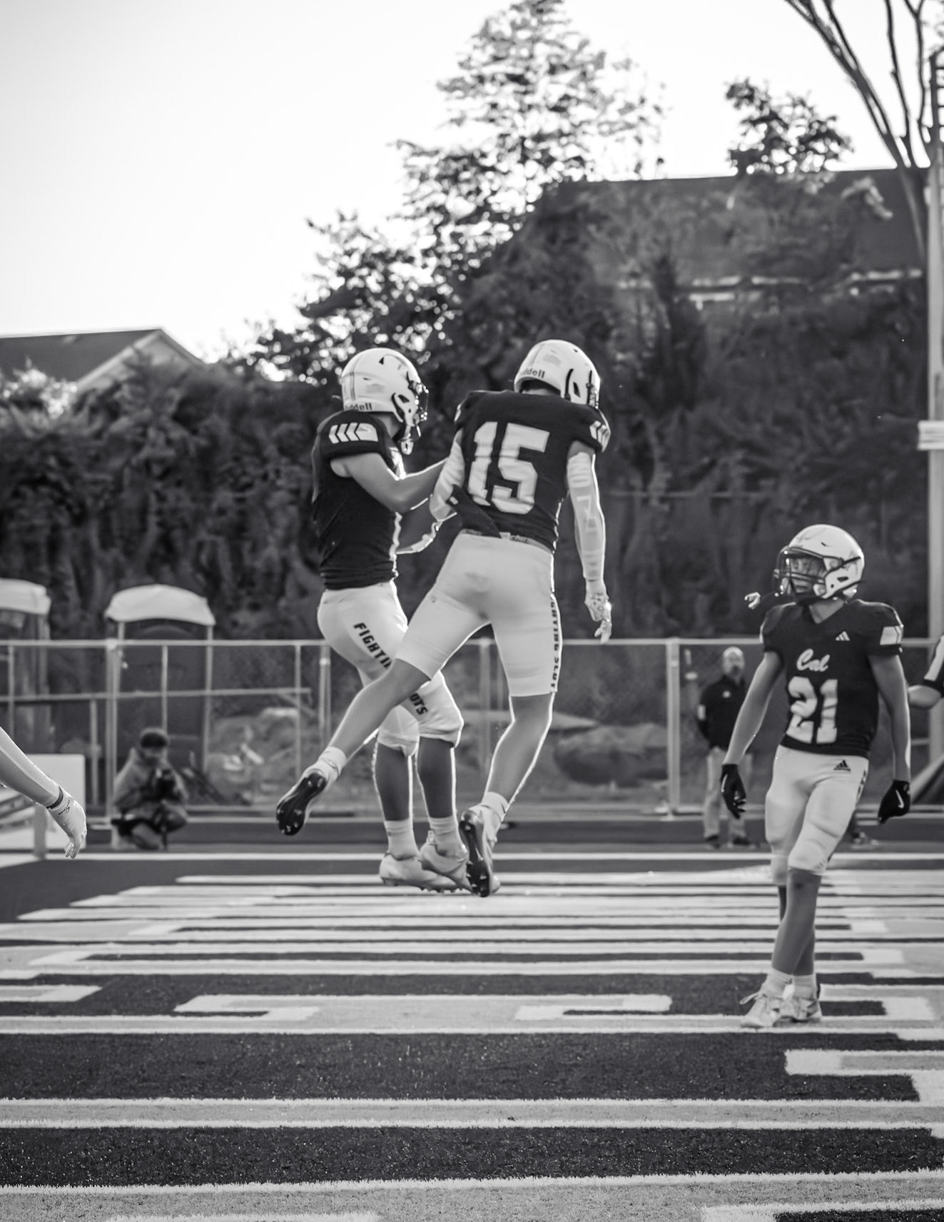Aaron Collins and Andrew Hannah celebrate in the air after a touchdown in their first game. (Photo by Mateus Santos)