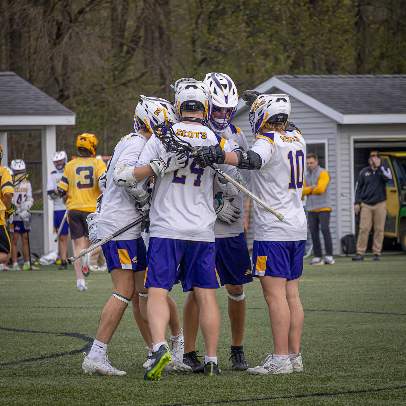 The team gathers together after their third goal, briefly celebrating before resetting for the next play (Photo by Abby Skibinski).
