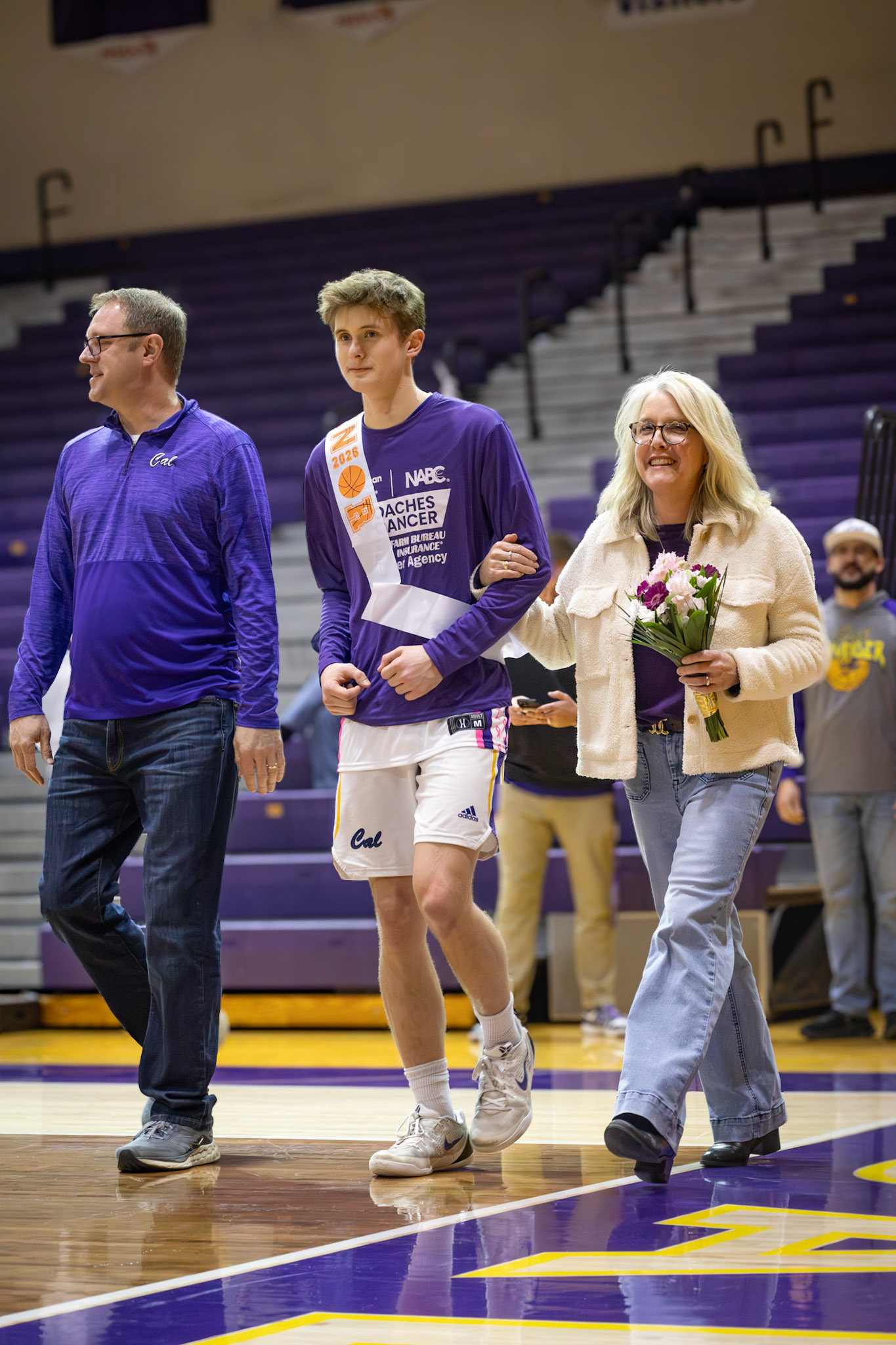 Luke Witvoet walks with his parents at Senior Night. (Photo by Aaron Pyper)