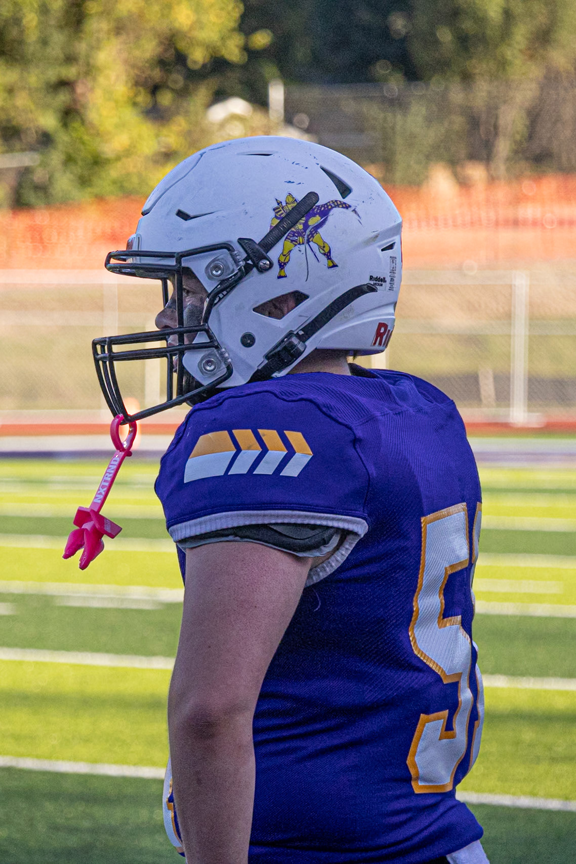 After hustling off the field, Brayden Smith takes a quick break to catch his breath before returning for the next play. (Photo by Ella-Grace Wickes)