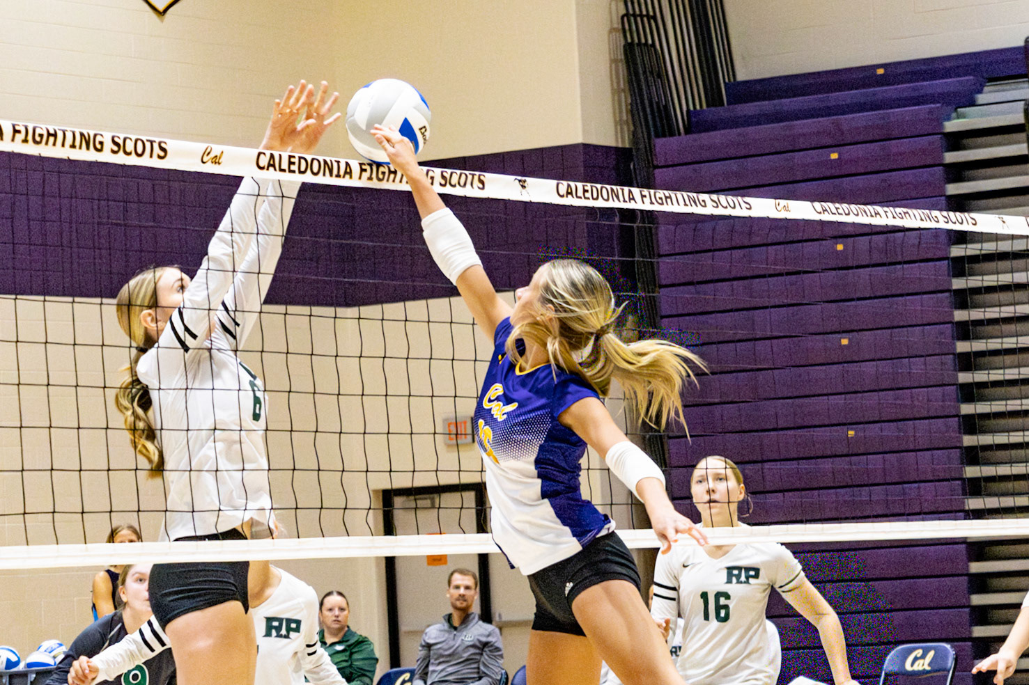 CLASH  As Brooke Haynes rises to net, she meets her opponent and battles for the point. (Photo by Aslyn Crocker)