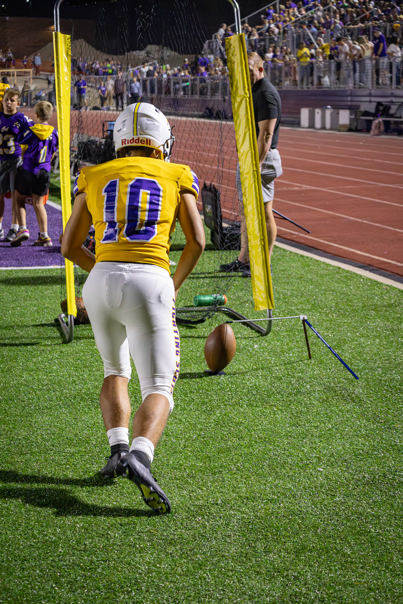 THE ZONE Landry Mueller shows remarkable focus on the sidelines, practicing his kickoff despite the excitement of the Homecoming game. (Photo by Taya Penoes)