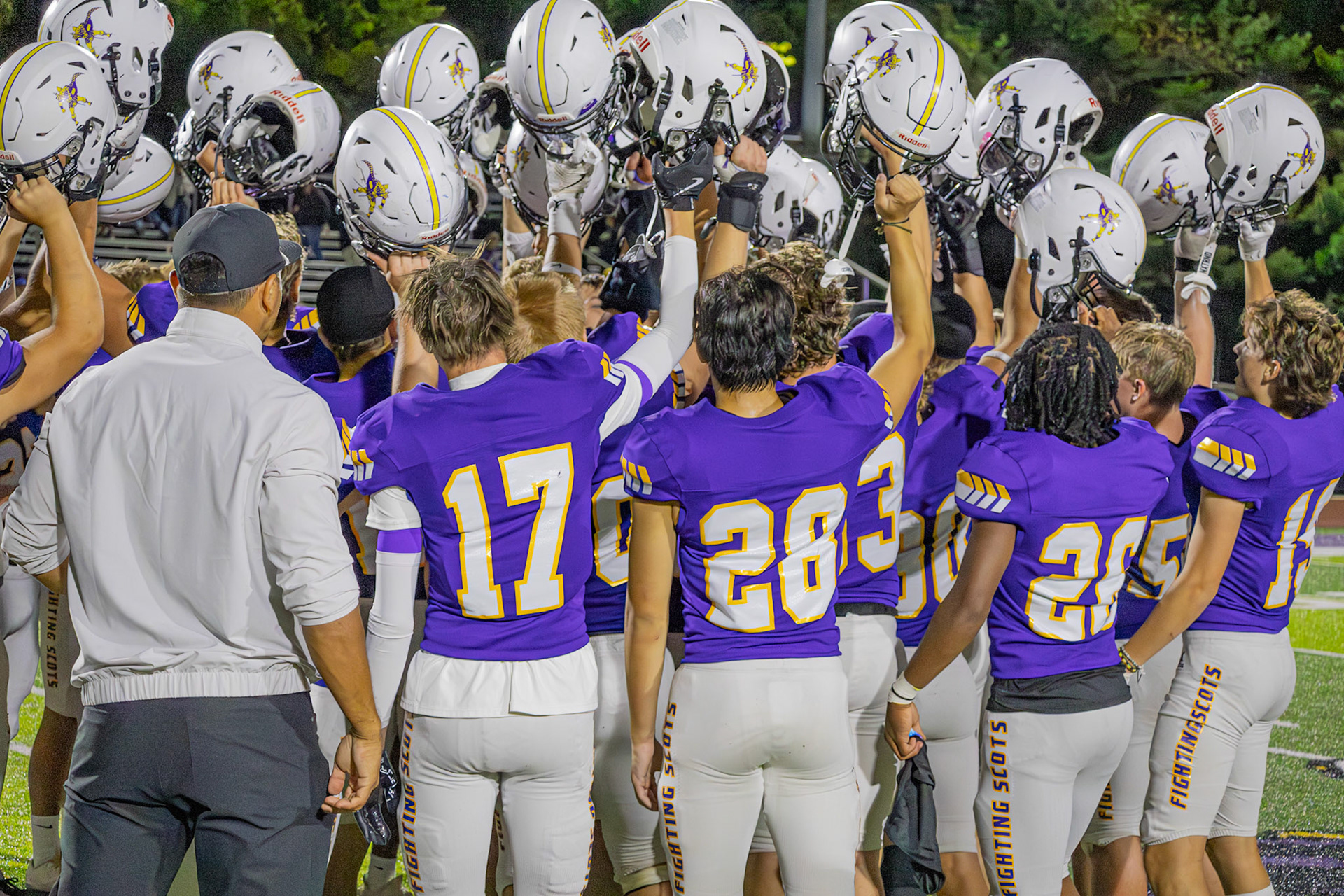 The Fighting Scots celebrate their win over Holy Windsor, the visiting team from Canada, raising their helmets after a hard-fought game.(Photo by Egan Otto)