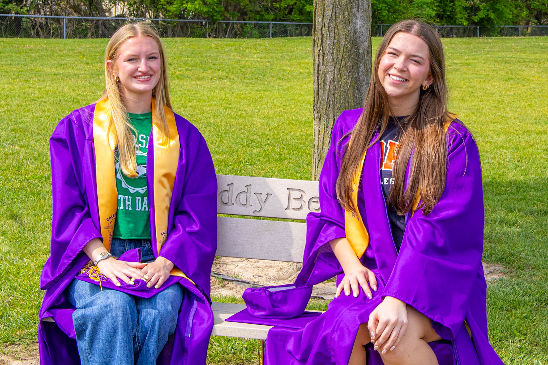 Peyton DeHorn and Lyla Keller revisit where their Caledonia childhood began -- at the buddy bench. (Photo by Sophie Grajewski)