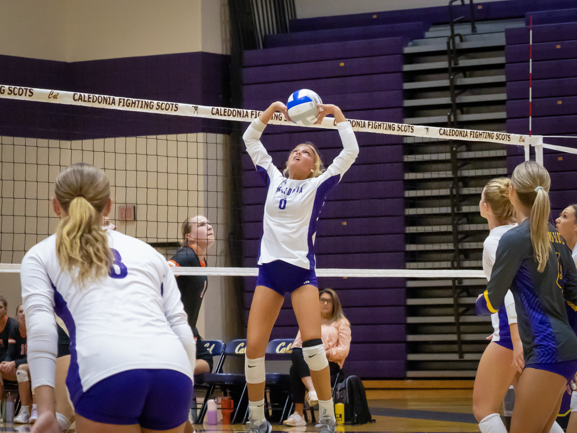 SET UP  Reese Stafford sets the ball up high to Kyla Charles going for the kill against Byron Center. (Photo By Tana Coates)