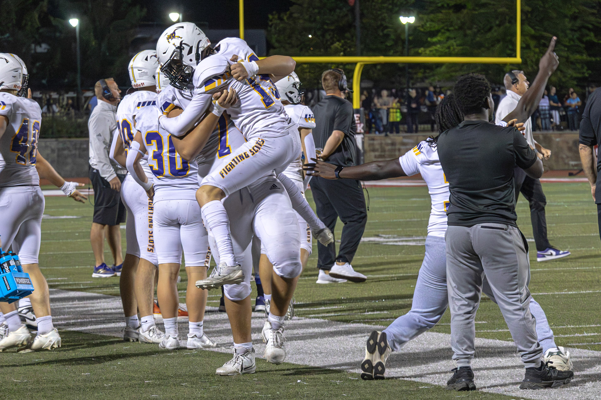 SKY HIGH  Parker Lipsman jumps into Brien Martin’s arms while the two get hyped up to start the second quarter of their game versus archrival East Kentwood (Photo by Abby Skibinski)