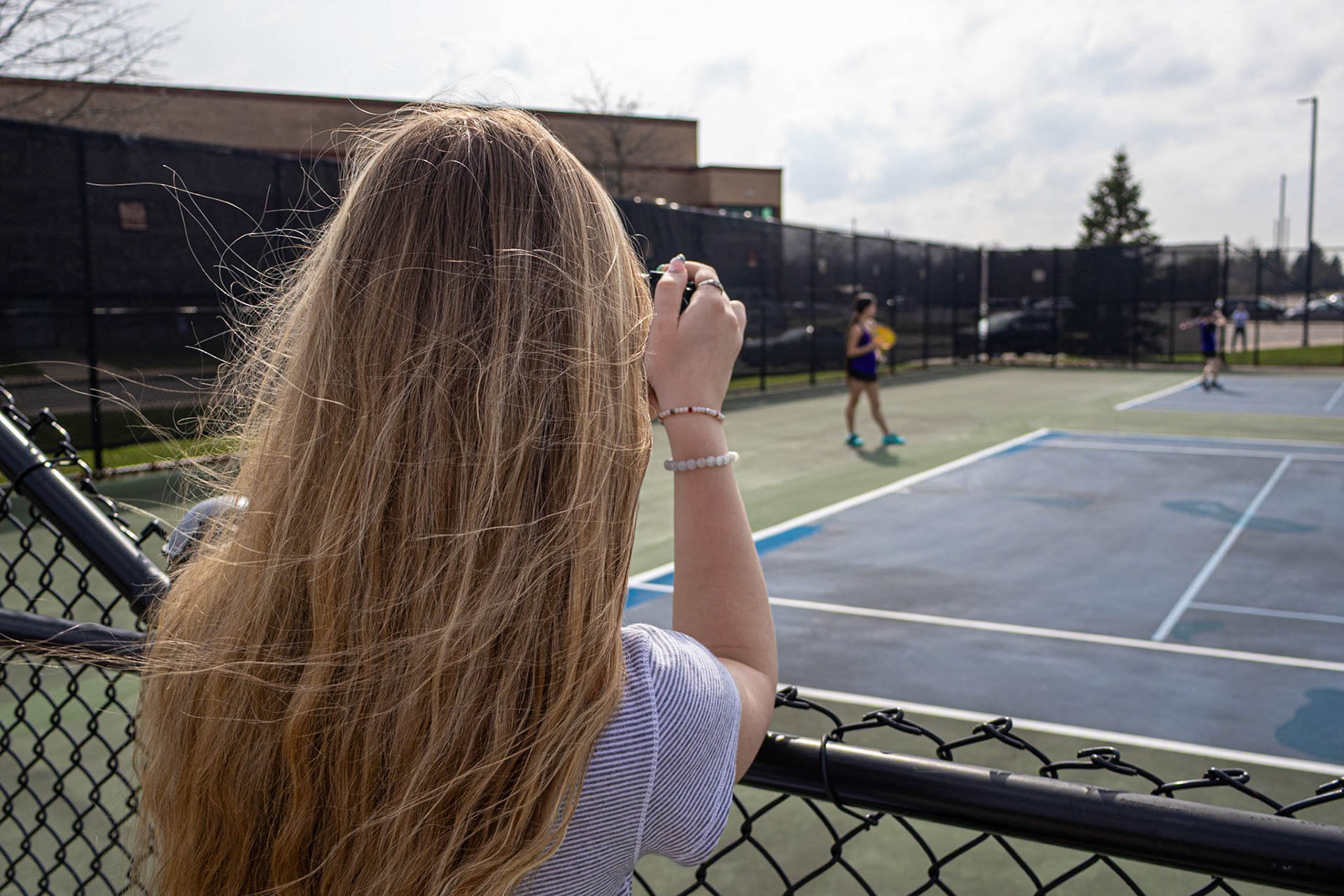 From behind the lens, Abby Skibinski catches Audrey Duong mid-match, capturing her concentration as the match unfolds point by point. (Photo by Hailey Thayer)