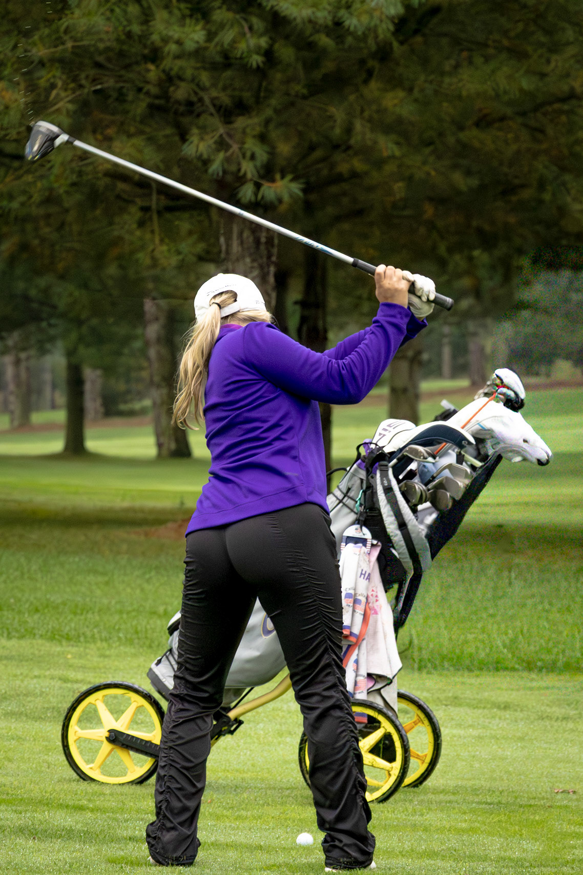 Senior Halle Stout takes a practice swing while working to refine her form. (Photo by Ryder Born)
