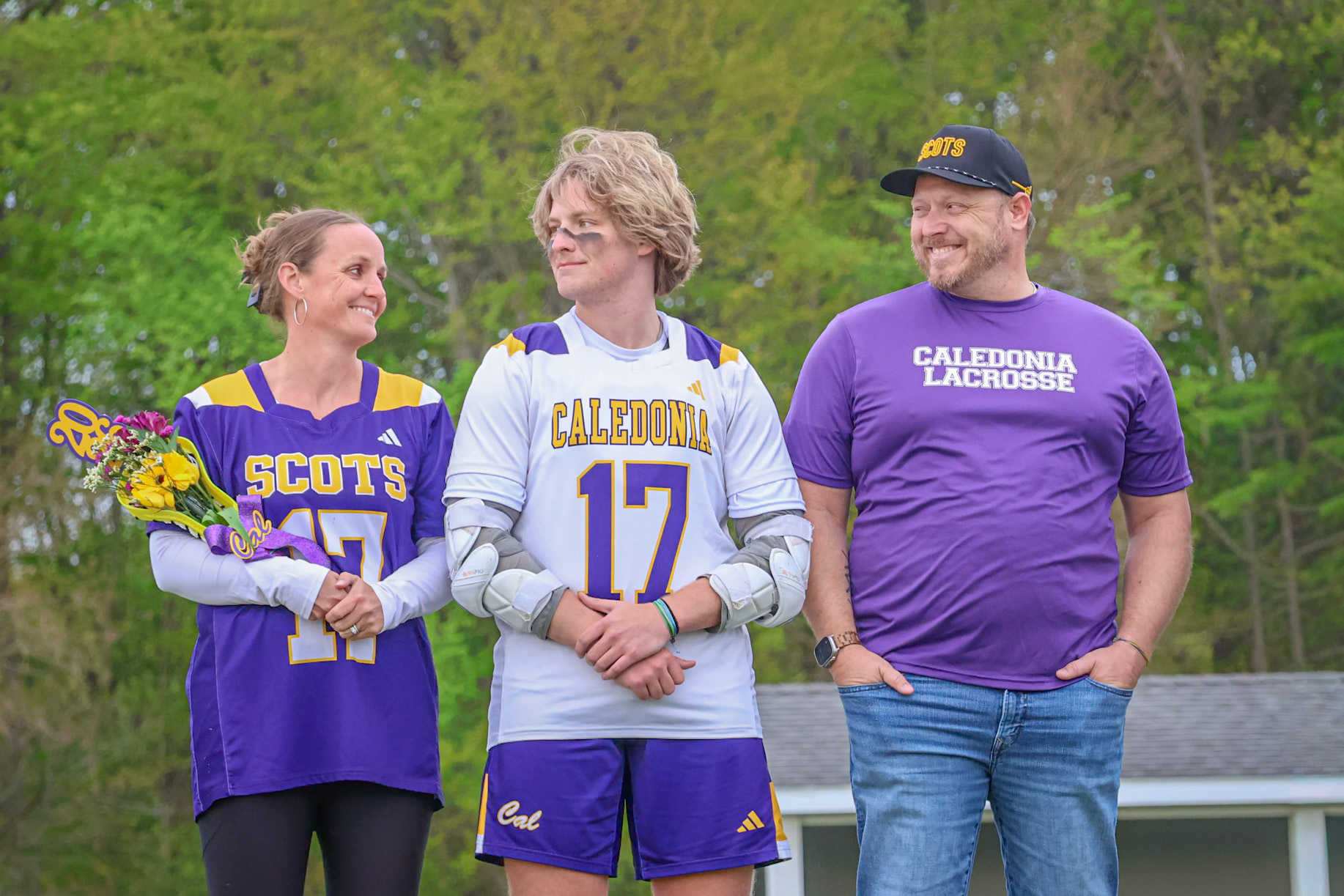 (9) Cohen Gregory stands with his parents as he reflects on his final high school lacrosse season. (Photo by Emma Garza)