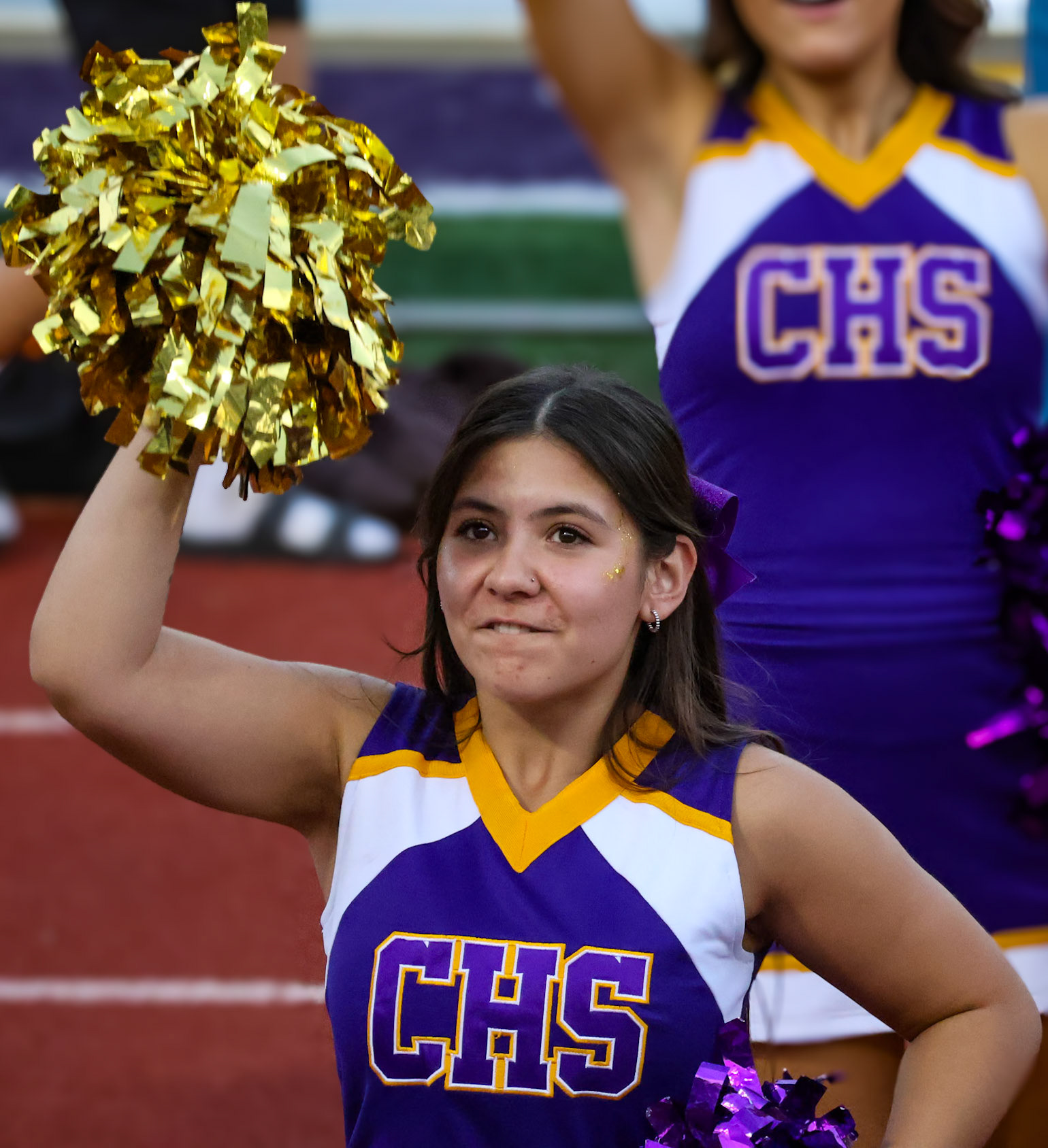 Senior Juliana Apo pumps up the crowd with a loud ‘Fight, Fight, Fight!’ at the Homecoming football game (Photo By Brianna Severson)