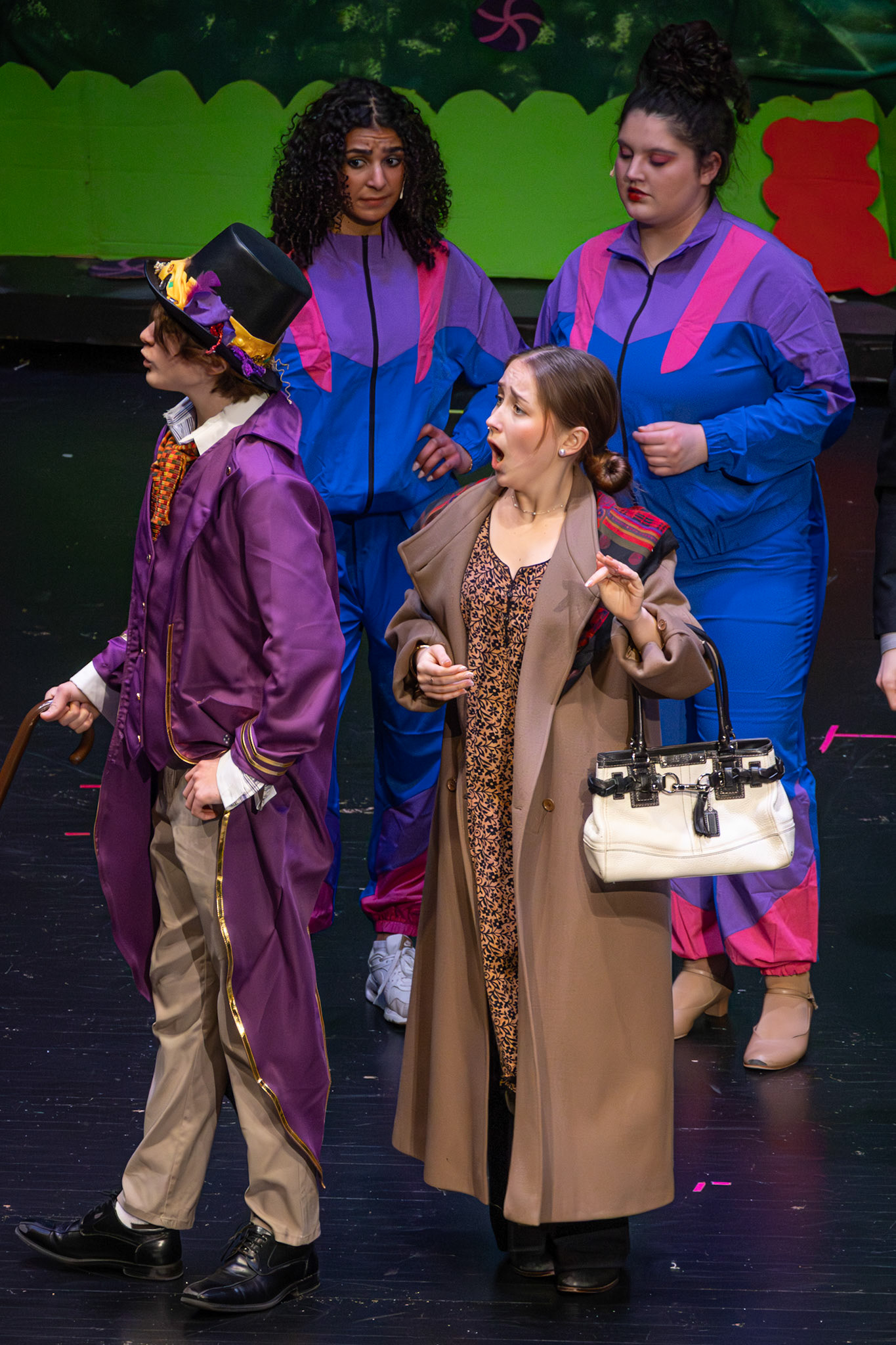 Augustus’s mom, played by senior Alma Cortes Diaz, looks completely surprised as Willy Wonka, played by senior Cody Winters, captivates the room with his words. (Photo by Mackenzie Popma)
