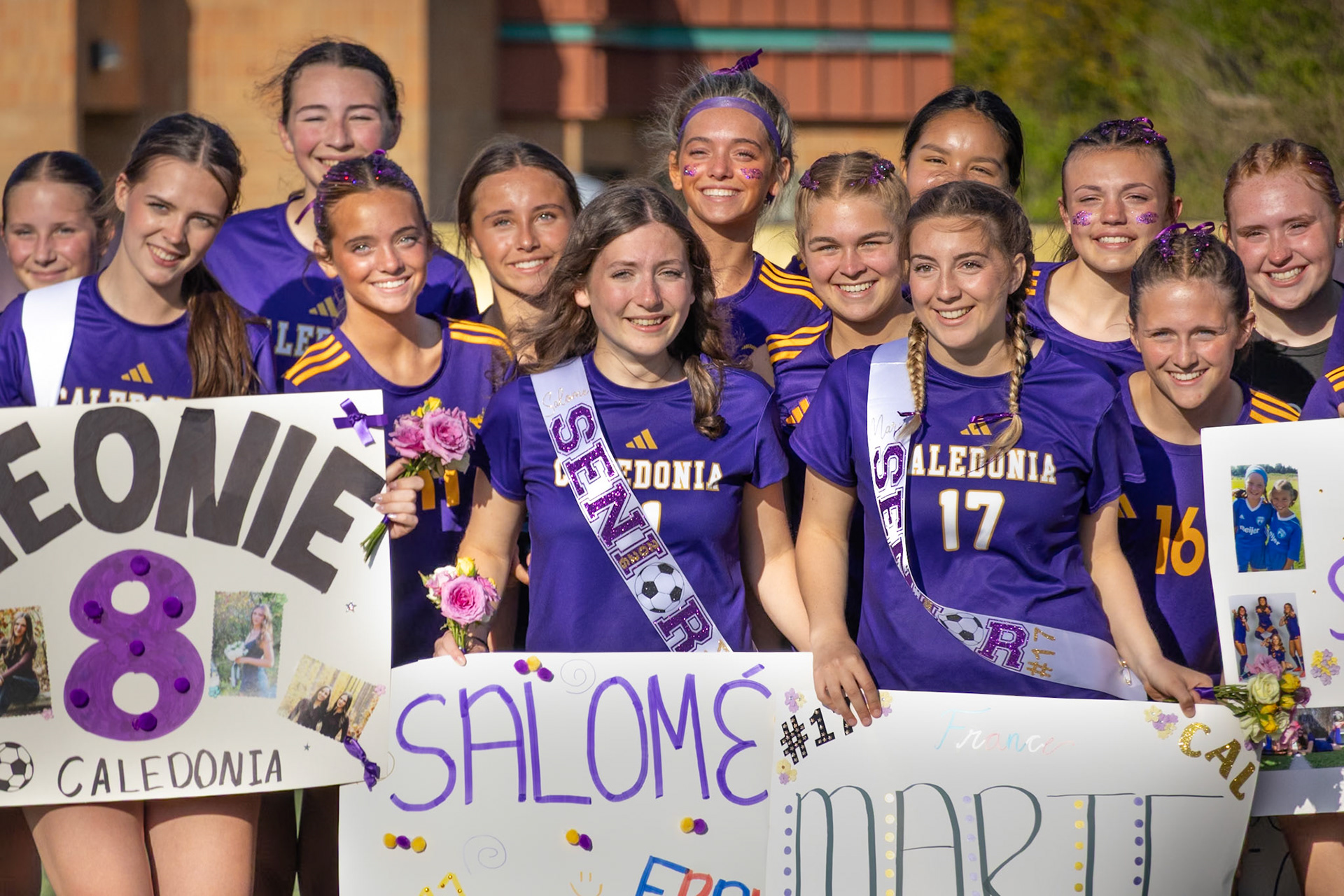 Exchange students Leonie Floetotto, Marie Bozso, and Salome Rouhier celebrating Senior Night with their team. (Photo by Ava LaBine)