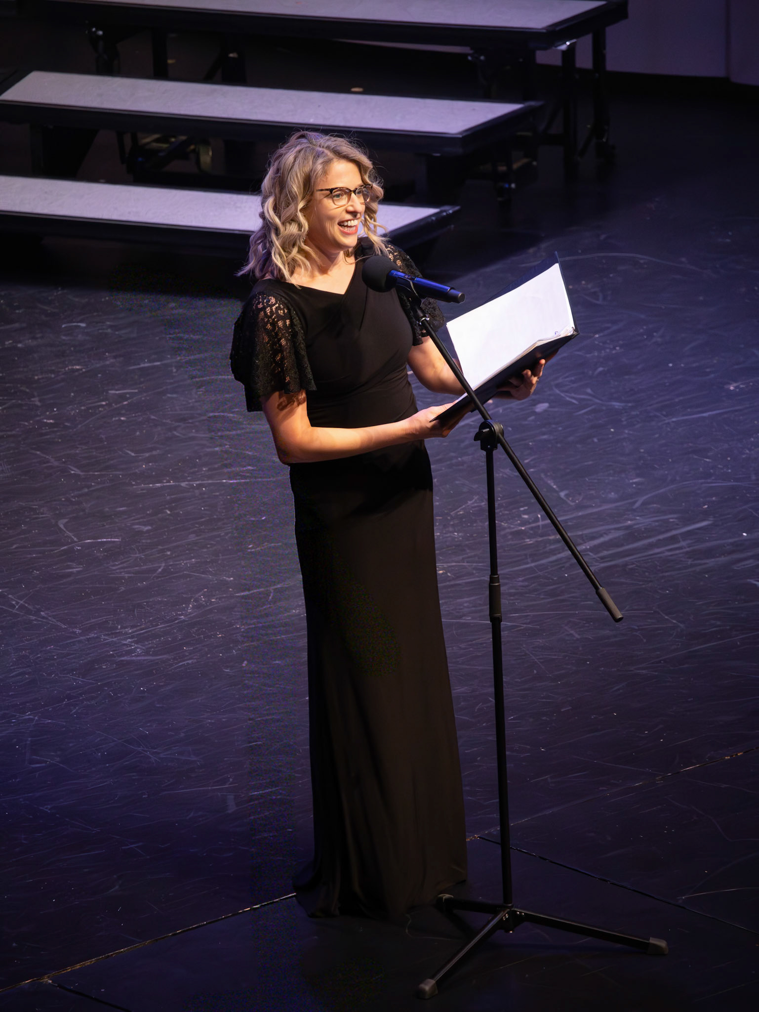 With the microphone in hand, Mrs. Stevens opens the Tenor/Bass Choir Concert with a warm welcome. (Photo by Addi Thornton)