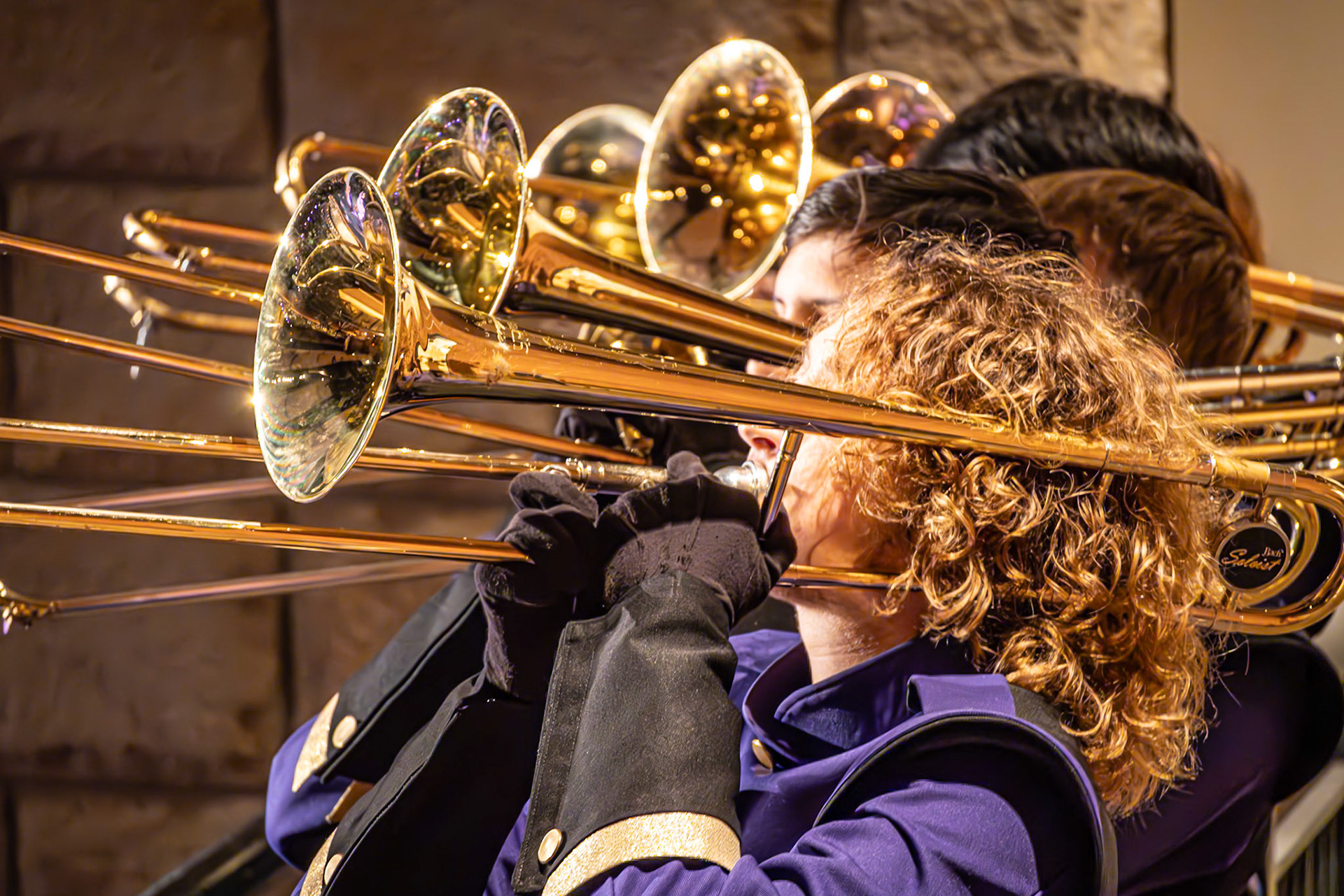 The trombone line performs together along the balcony. (Photo by Molly Larson)