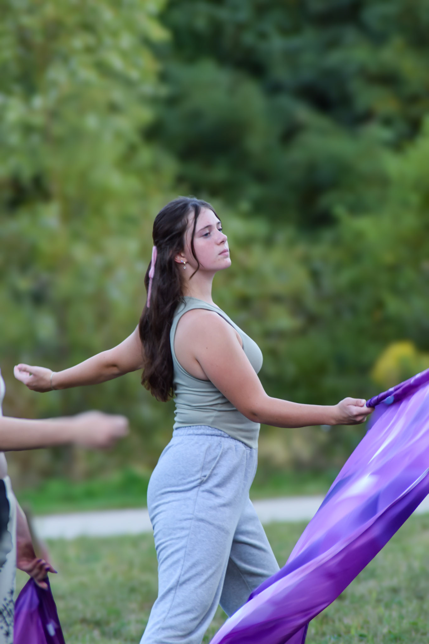 THE FLOW Riley Reimbold glides through color guard practice. (Photo by Ollie Fox)